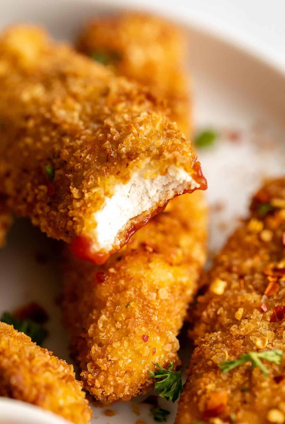 gluten free chicken tenders with a bite taken out to show texture