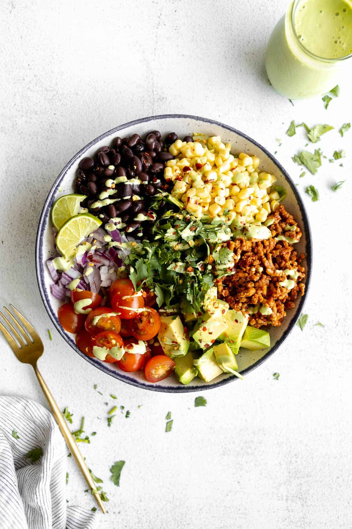 vegan taco salad in a bowl with the ingredients in sections