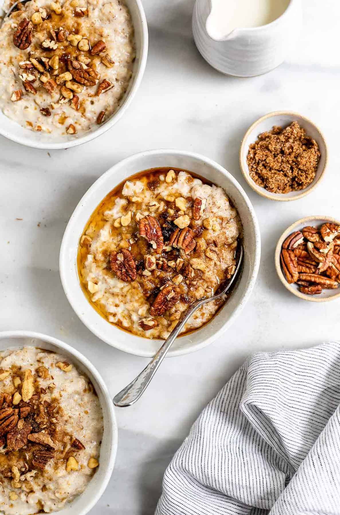 Maple sugar oatmeal recipe in a bowl with pecans on top.