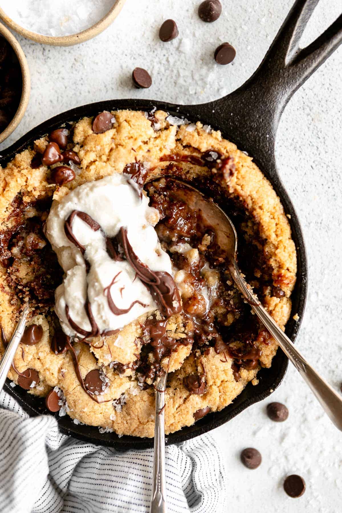 mini skillet cookie with ice cream on top with a spoon on the side