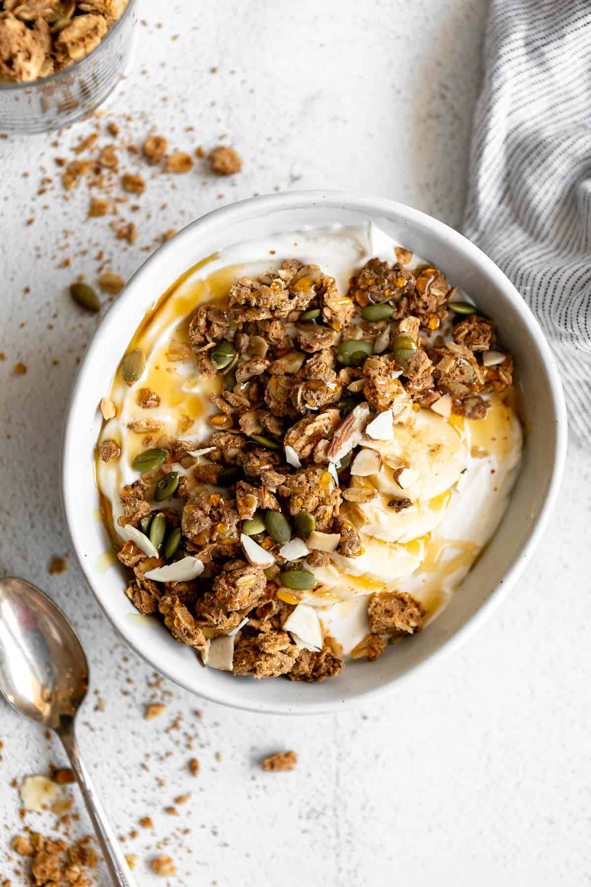high protein granola in a bowl with yogurt and honey