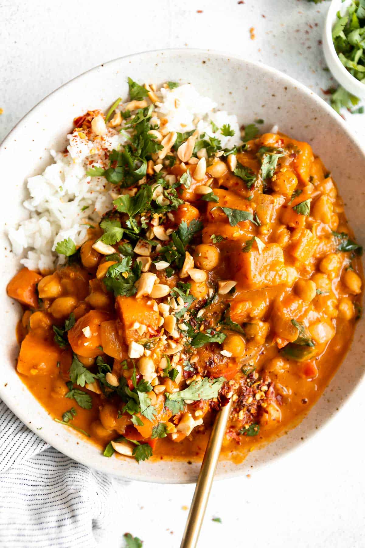sweet potato peanut butter curry in a bowl with white rice