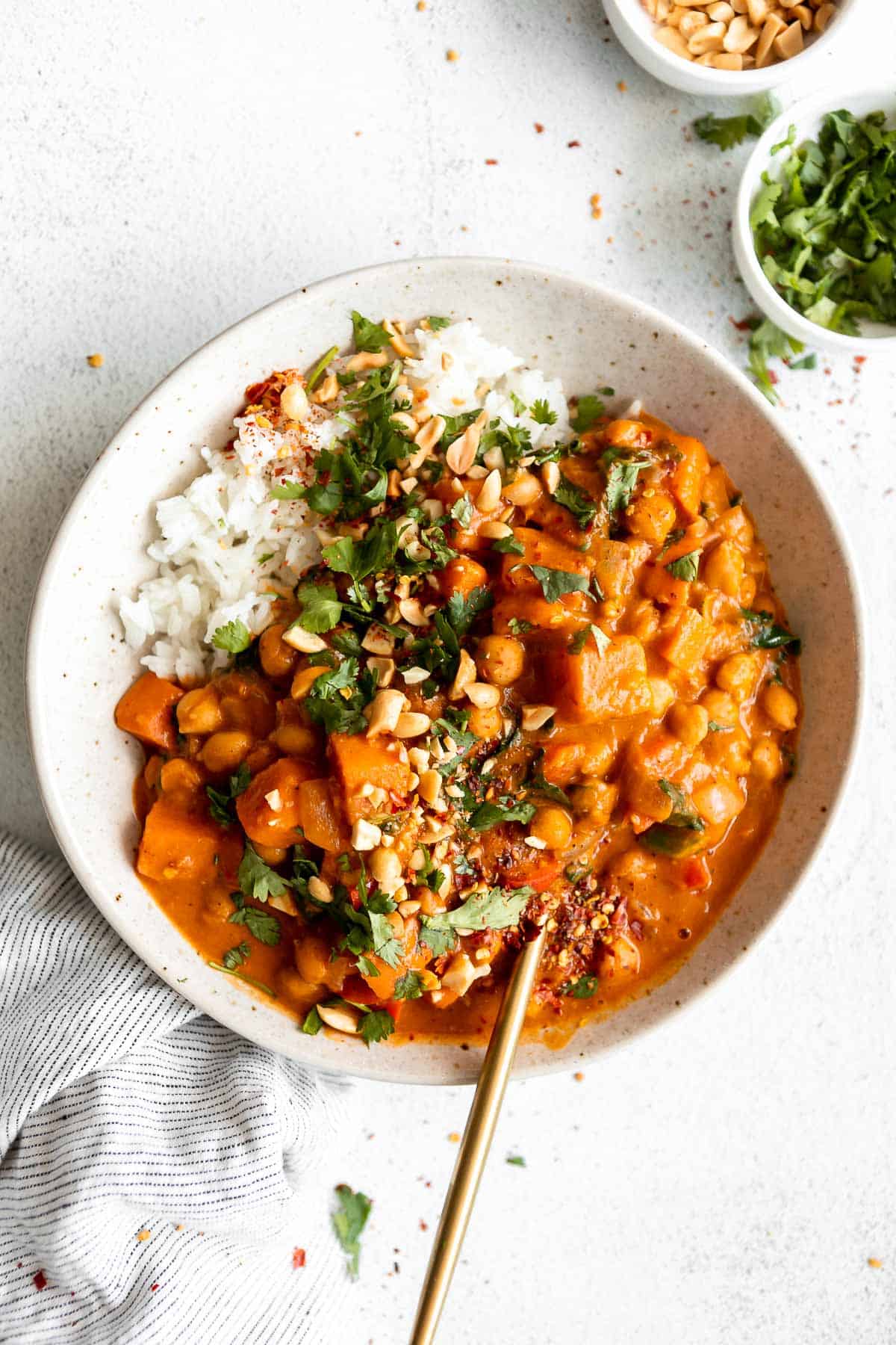thai peanut butter chickpea curry in a bowl with white rice