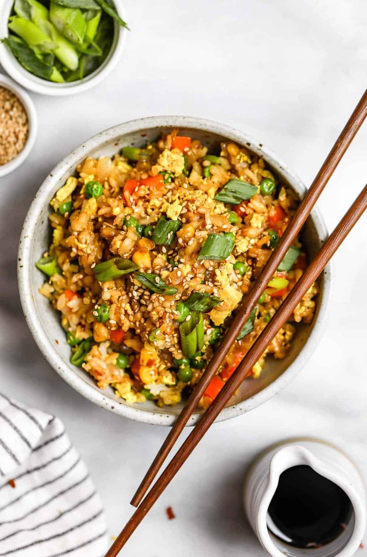 One bowl of vegan fried rice with chopsticks on the top.