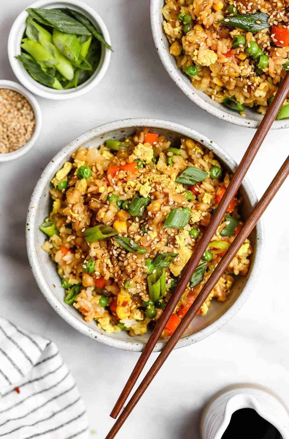 vegan fried rice in a bowl with chopsticks on the side