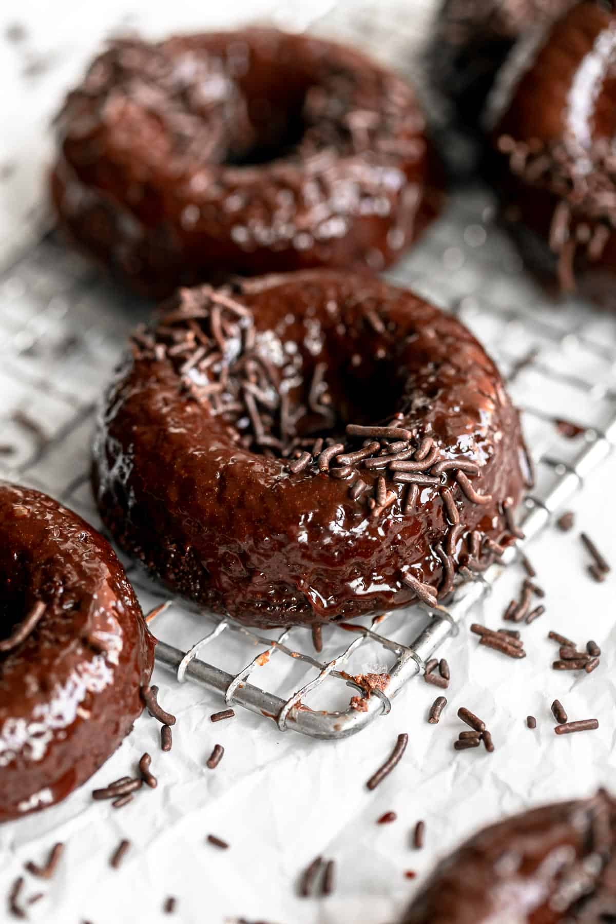 vegan gluten free chocolate donuts on a wire rack