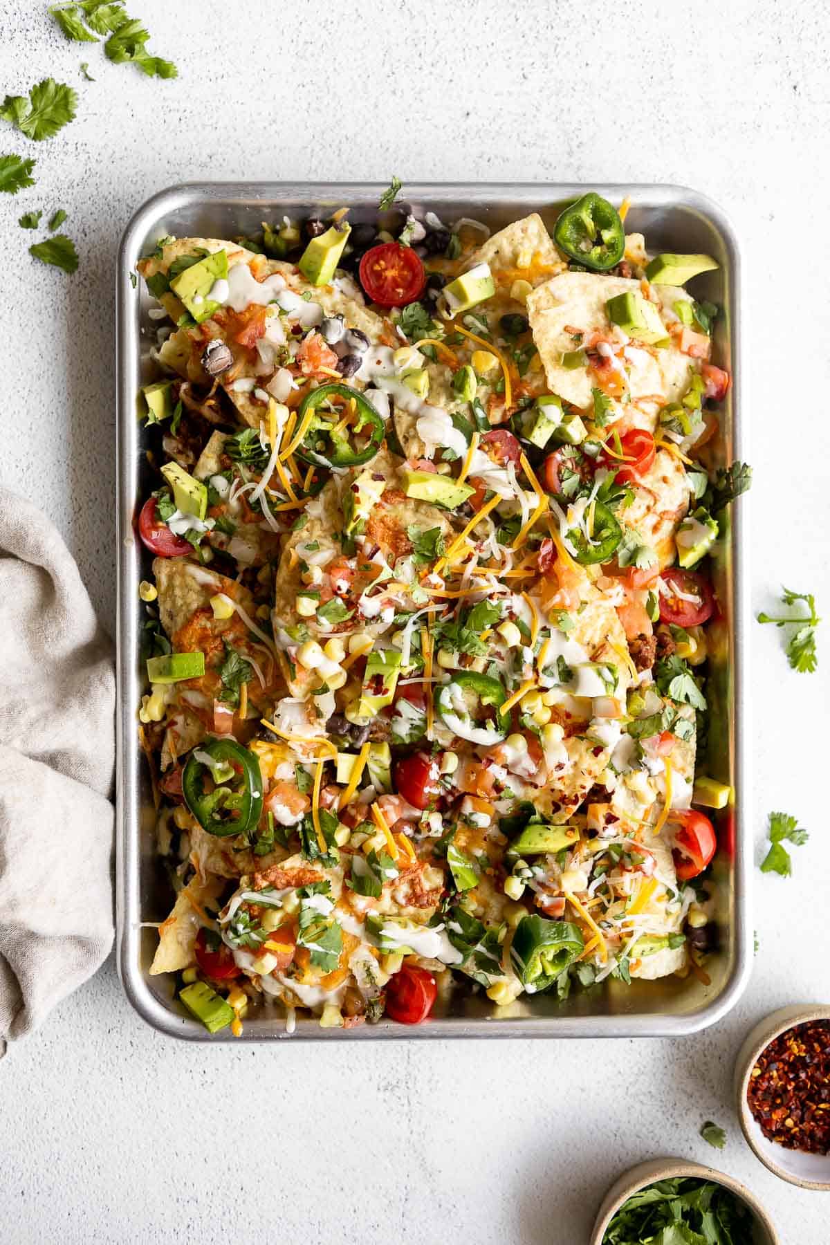 loaded veggie nachos with cilantro and cashew queso on top