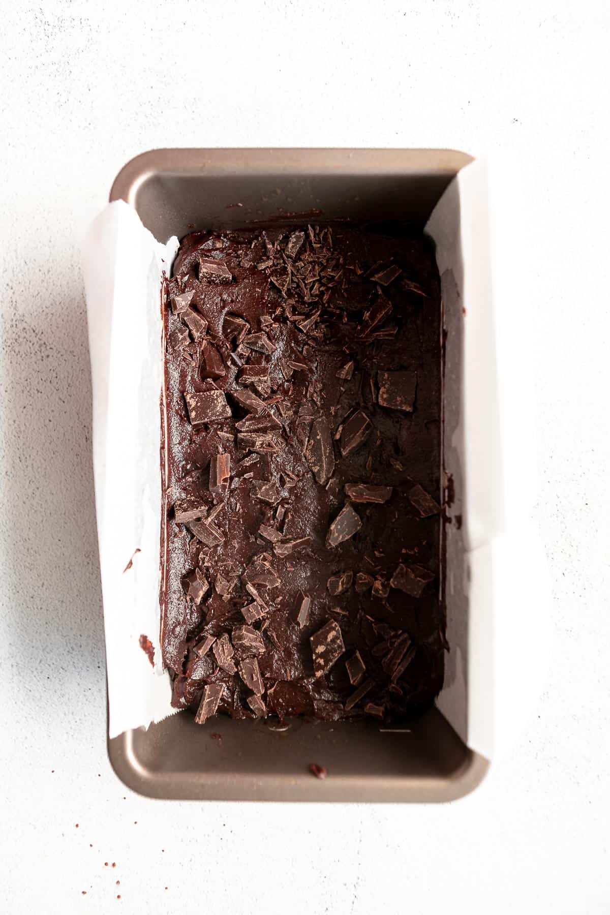 brownie batter in a loaf pan before baking