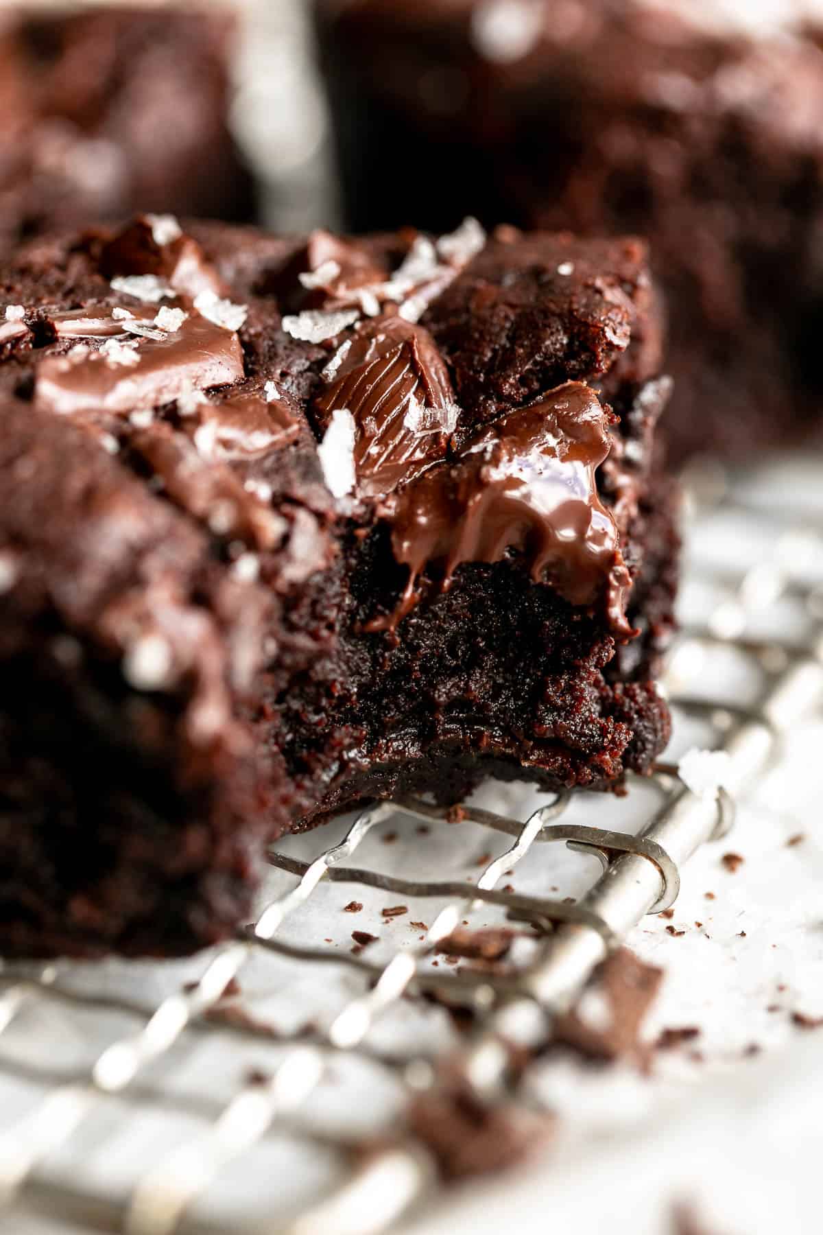 up close of one eggless brownie with a bite taken out