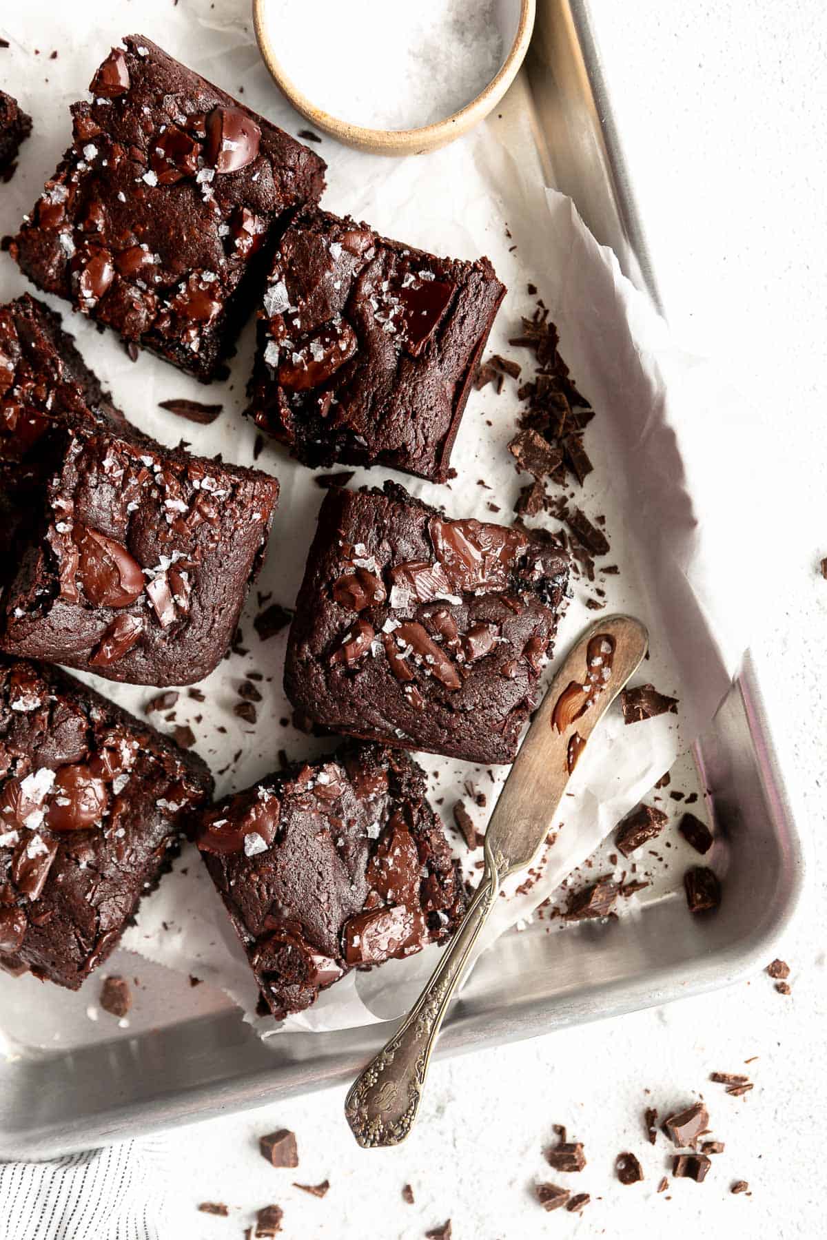 eggless brownies on a baking pan with chocolate chunks
