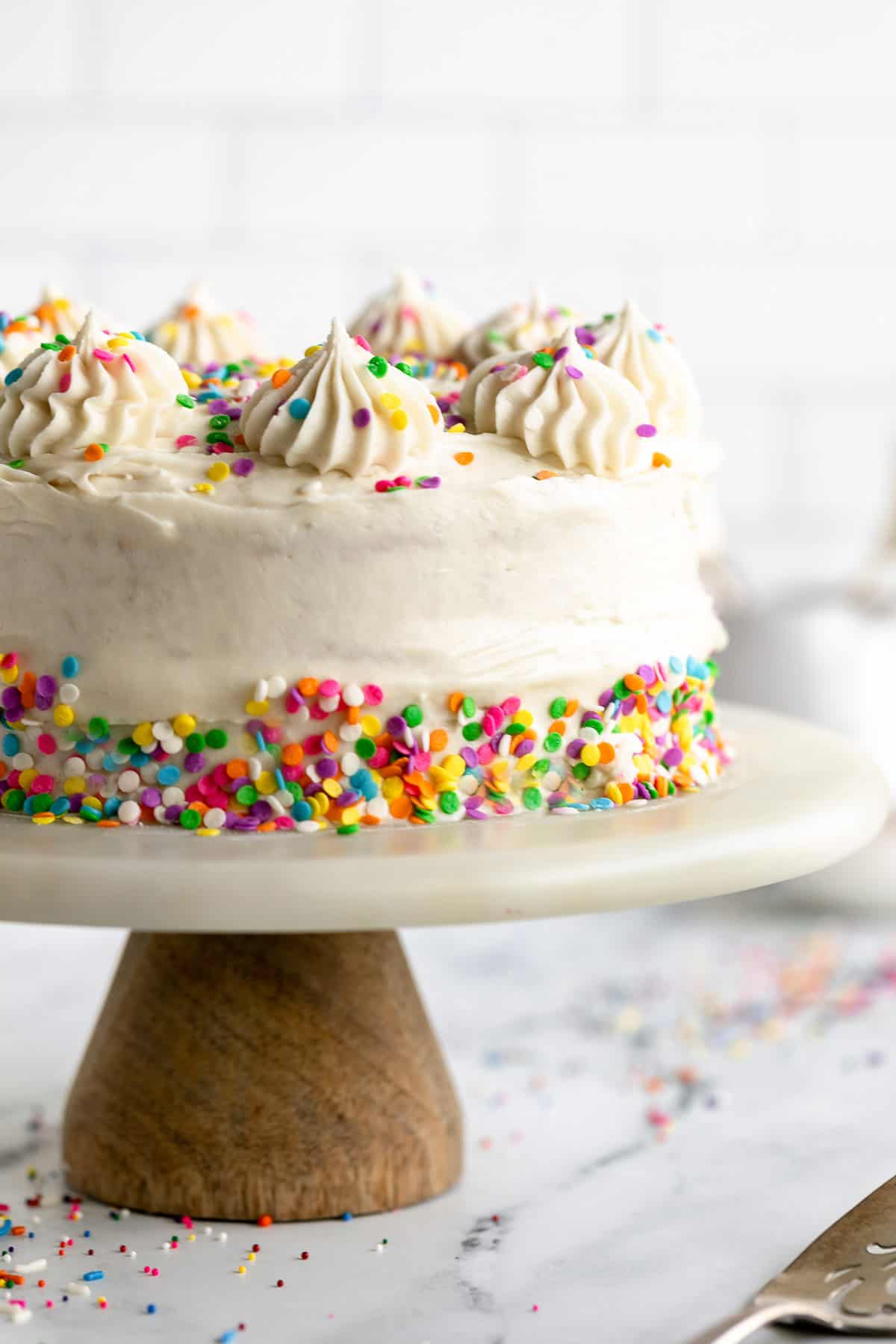 gluten free vanilla cake with rainbow sprinkles and frosting