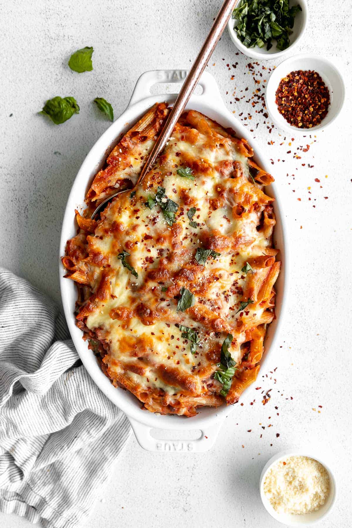vegan pasta bake in a pan with fresh basil