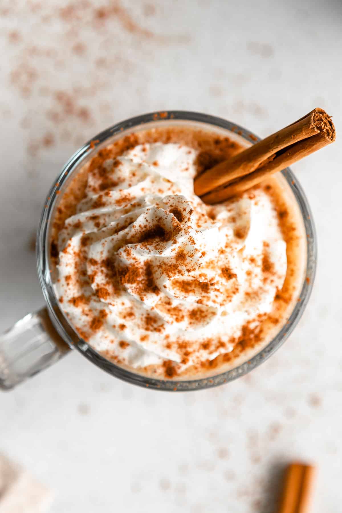 overhead shot of the pumpkin spice latte in a mug with whipped cream