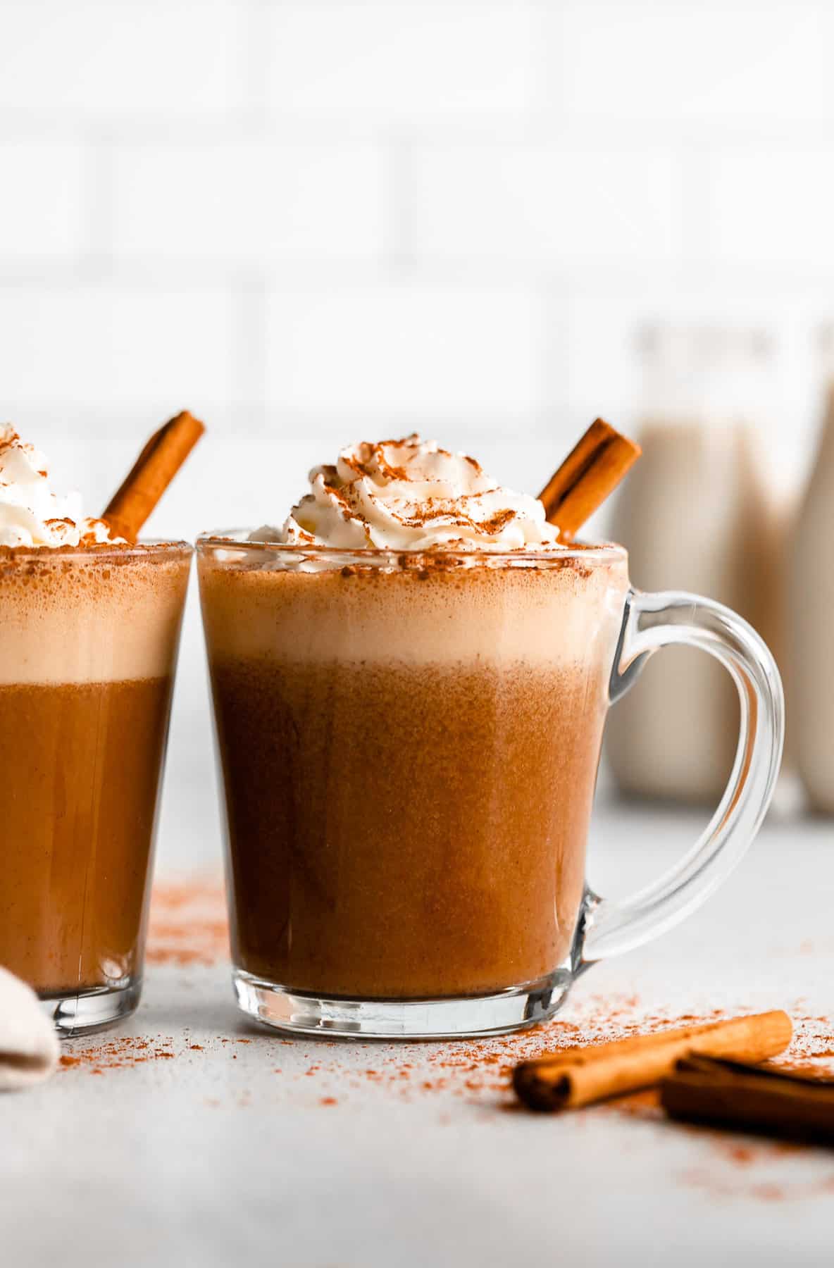 vegan pumpkin spice latte in a mug with cinnamon sticks