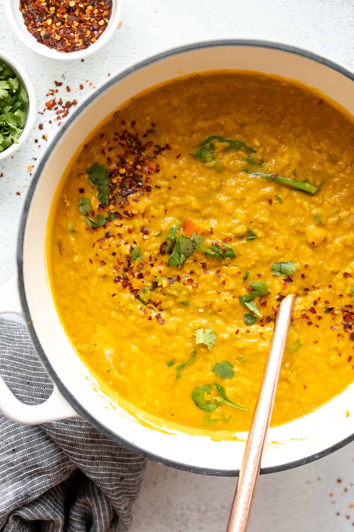 red lentil dahl in a pot with red pepper flakes