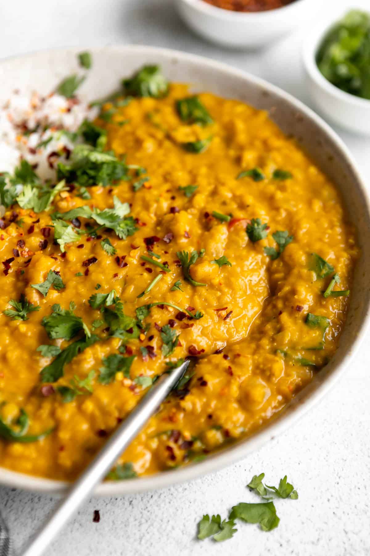 angled view of the red lentil dahl recipe in a bowl