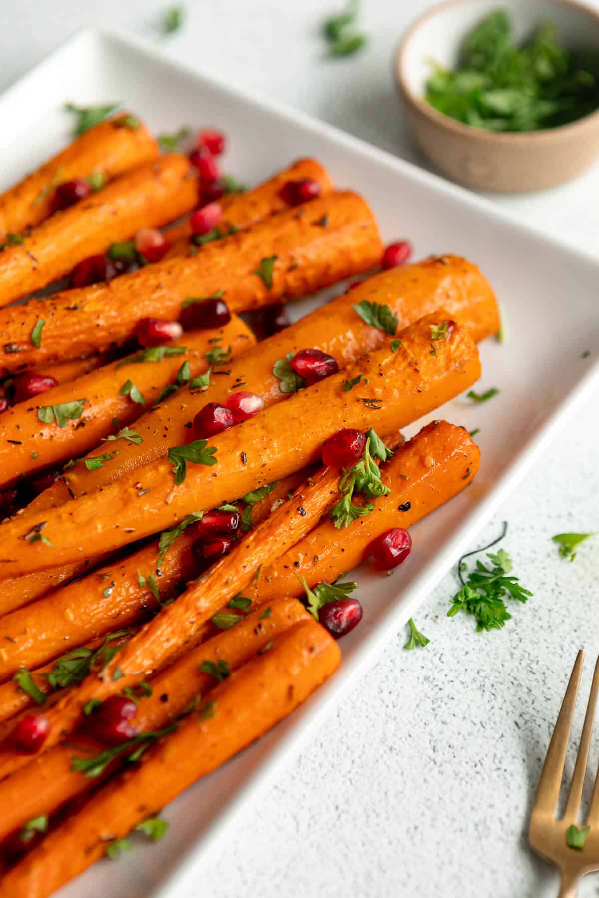 air fryer carrots on a white plate with parsley