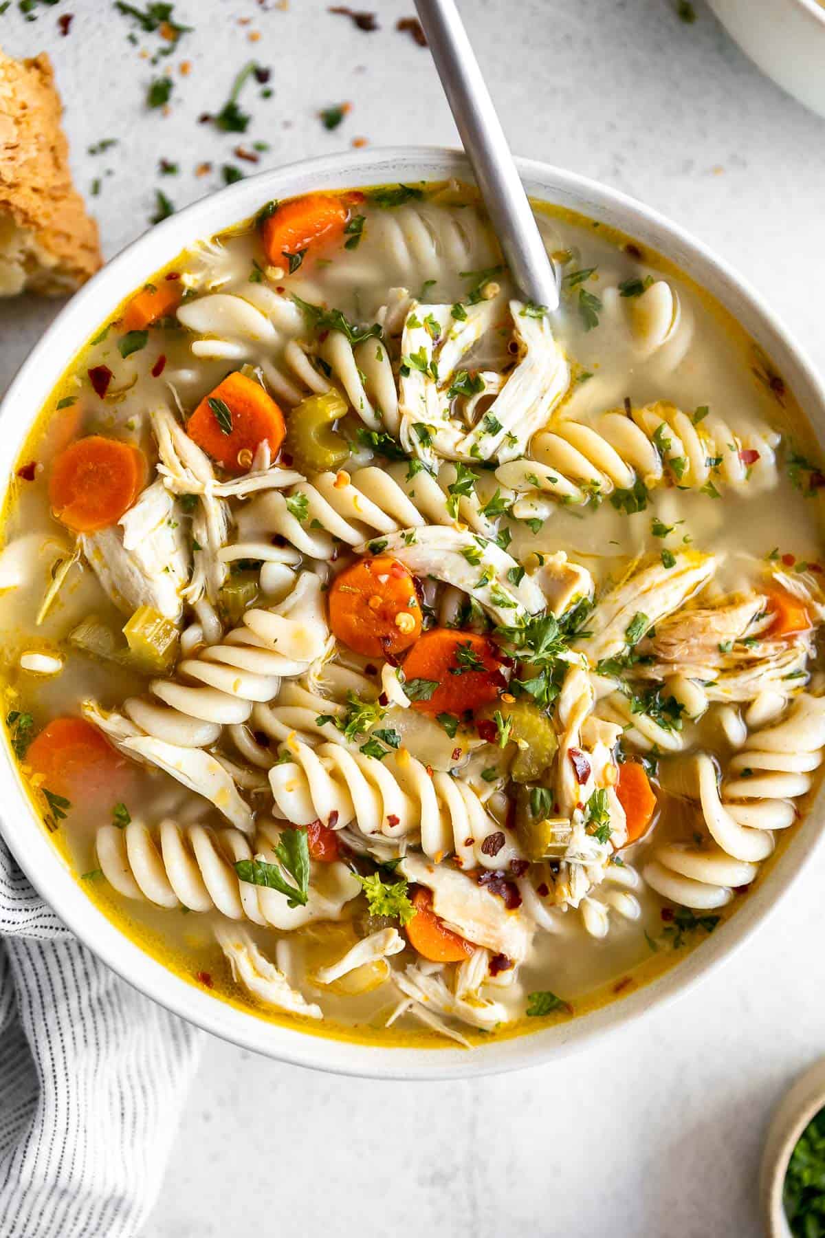 gluten free chicken noodle soup in a bowl with rotini pasta
