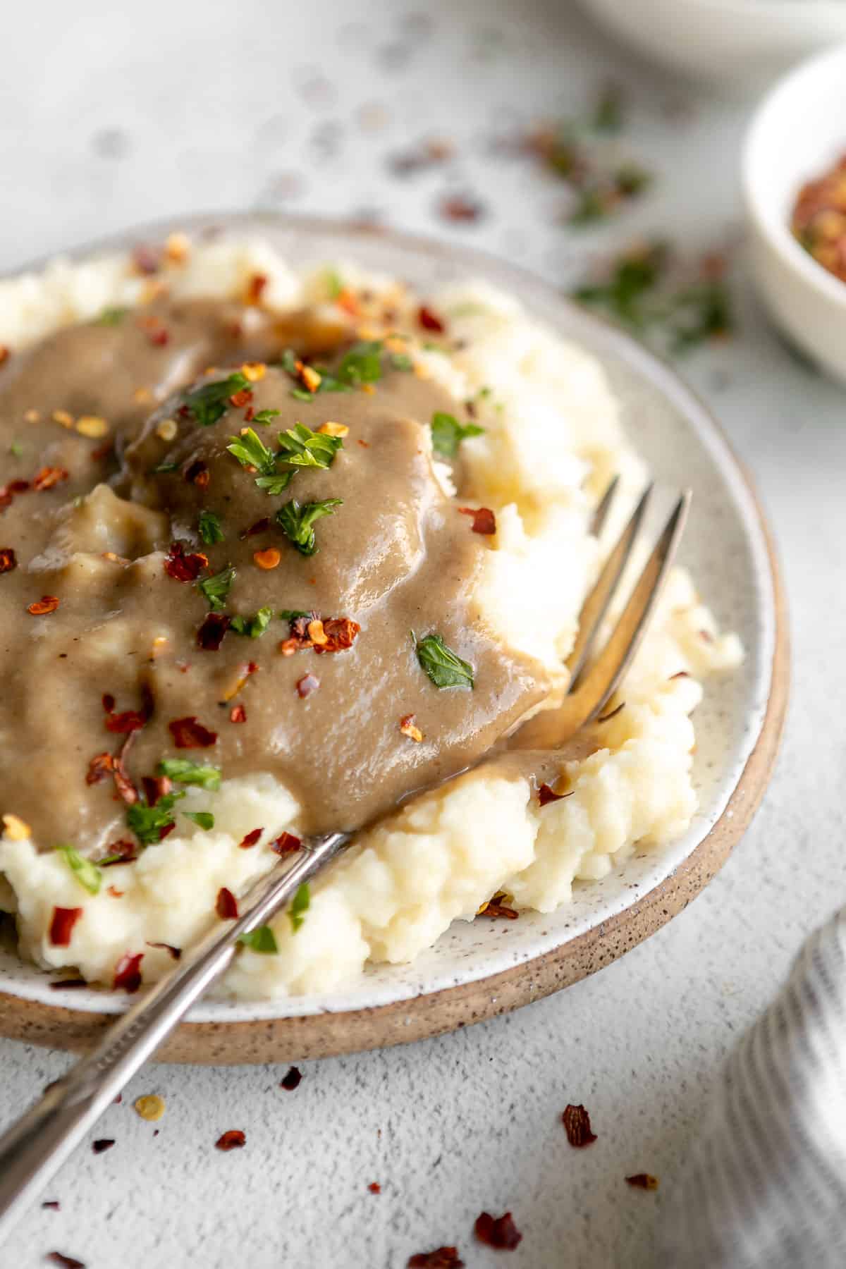 vegan mushroom gravy on top of healthy mashed potatoes on a plate