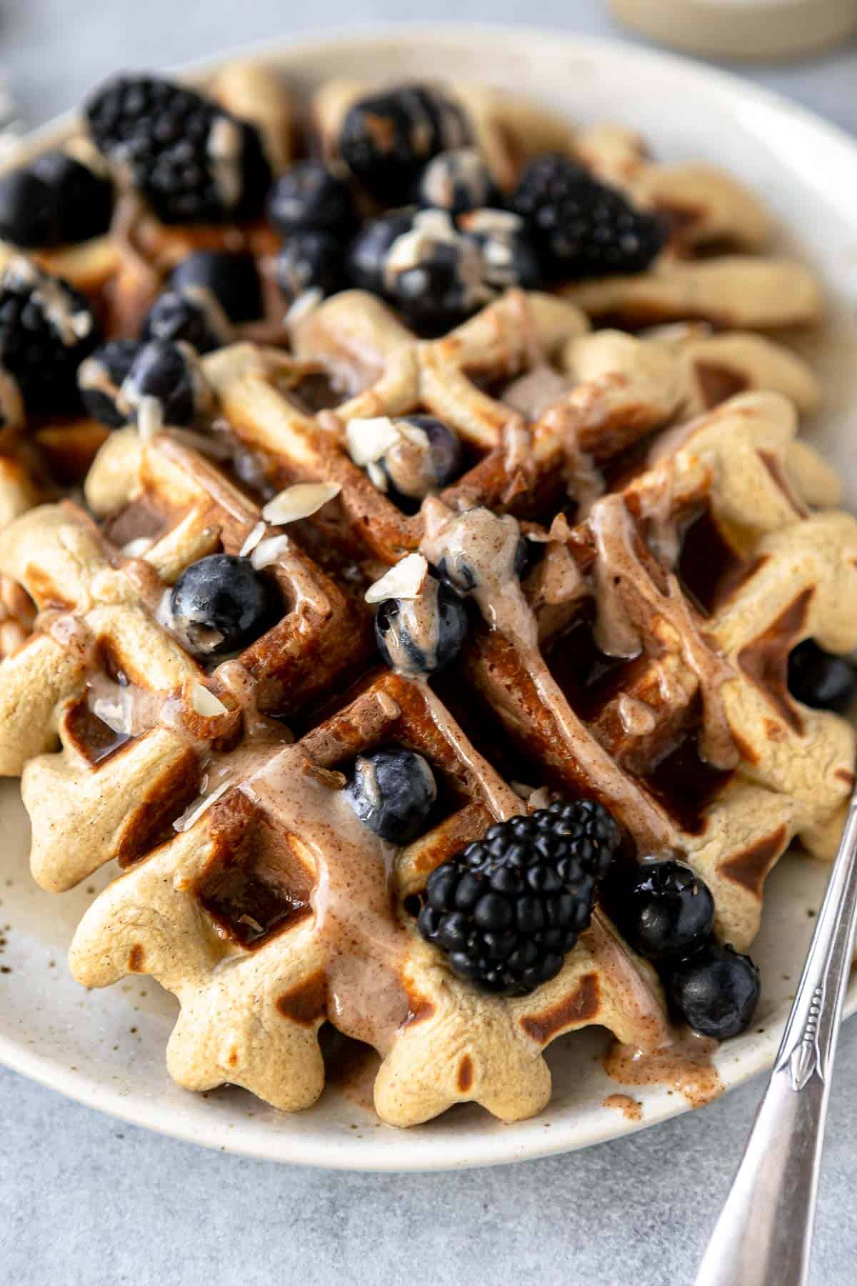 protein waffles on a plate with almond butter
