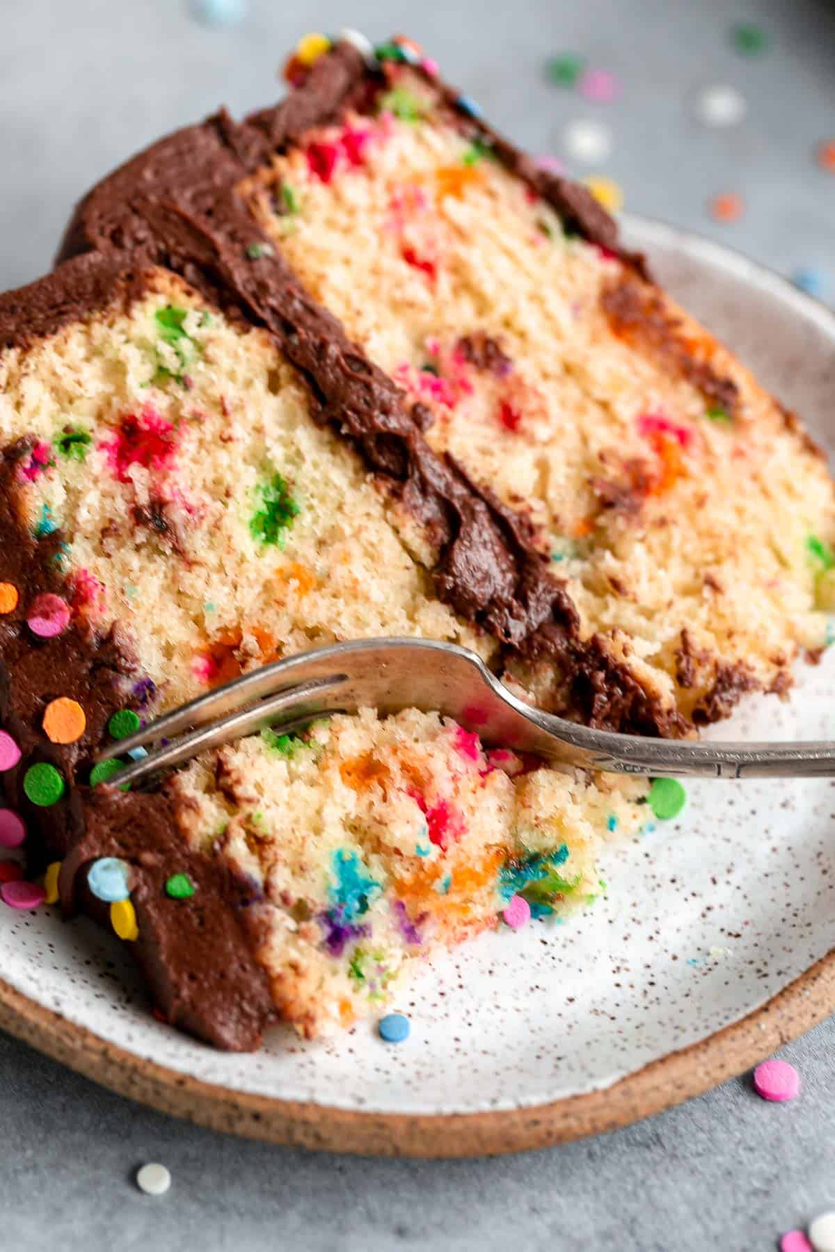 one slice of cake on a plate with a fork