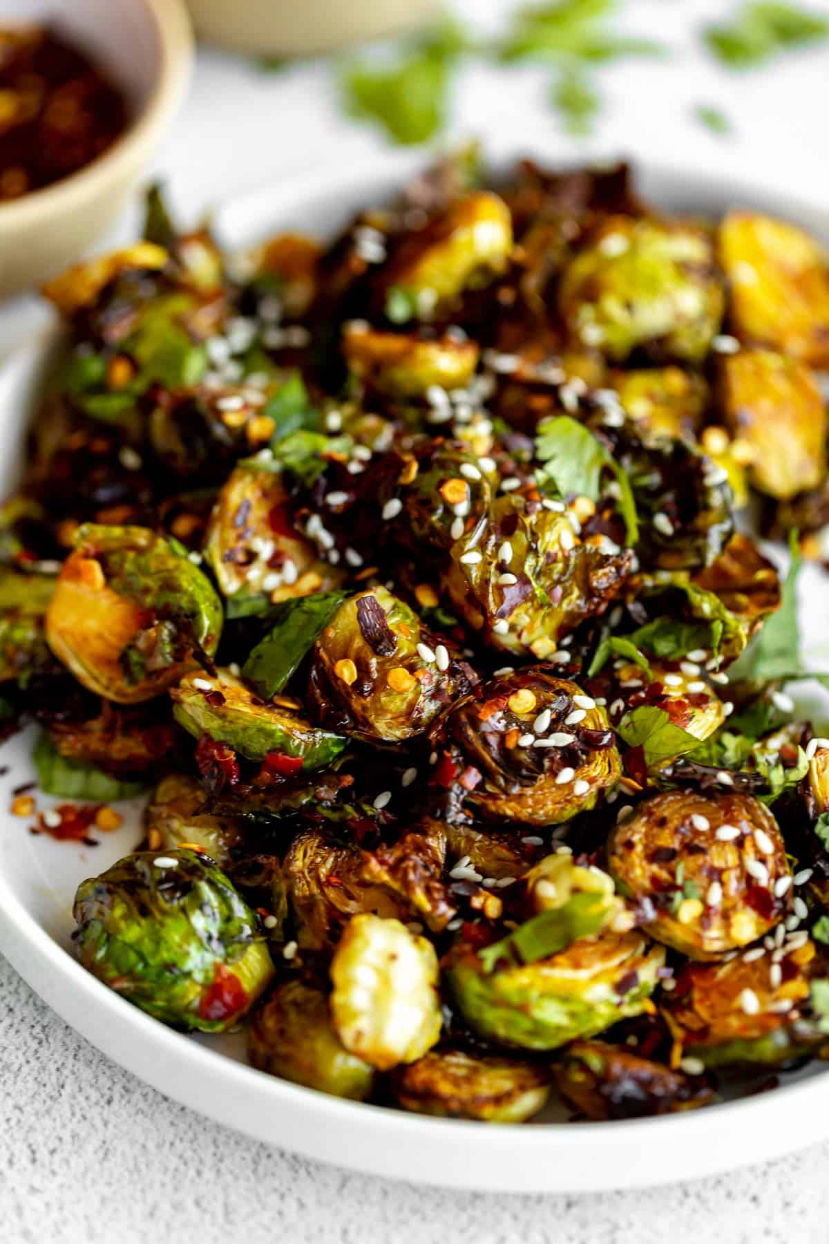 air fryer brussels sprouts on a plate with sesame seeds