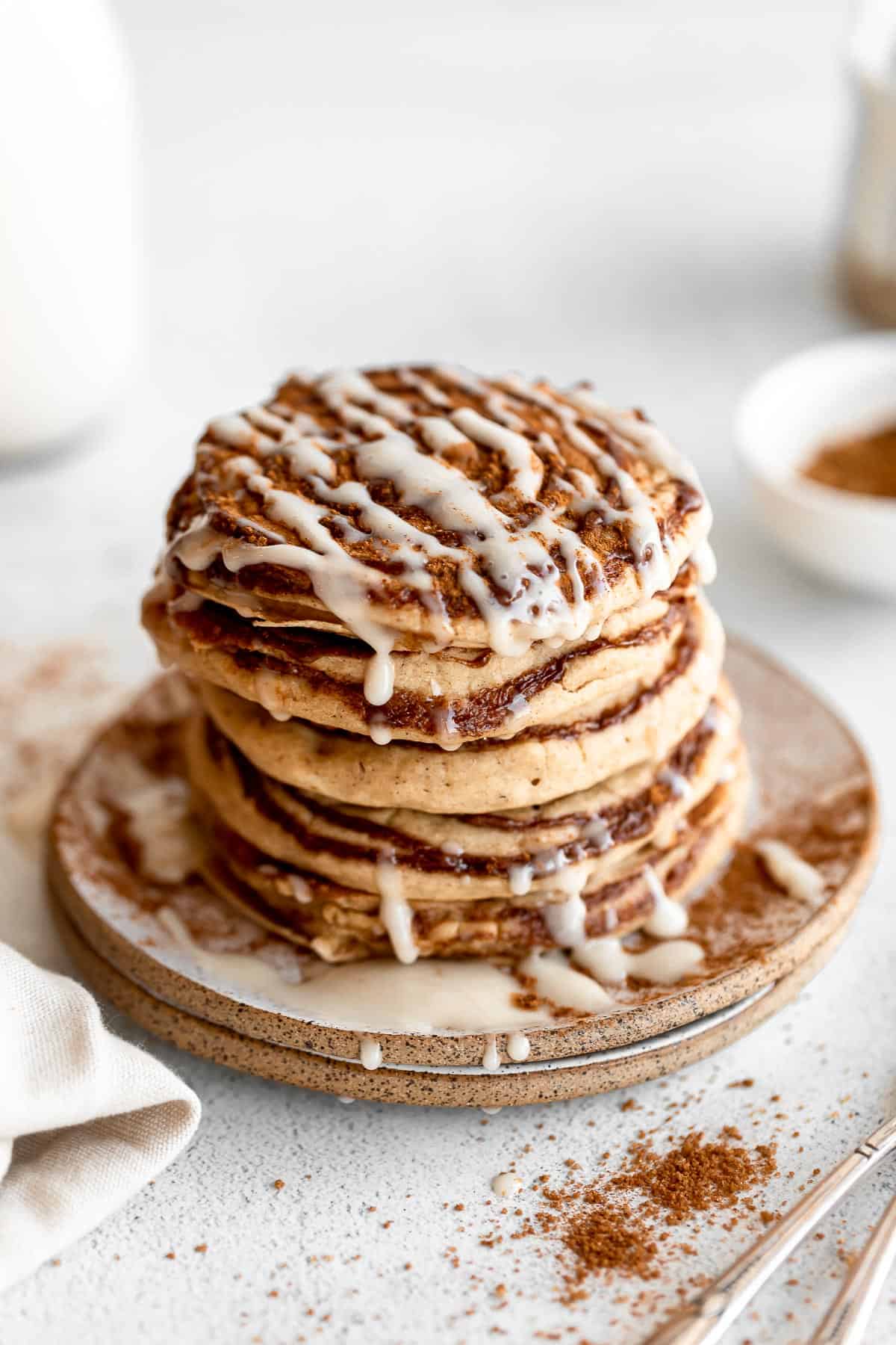 cinnamon roll pancakes with glaze on top