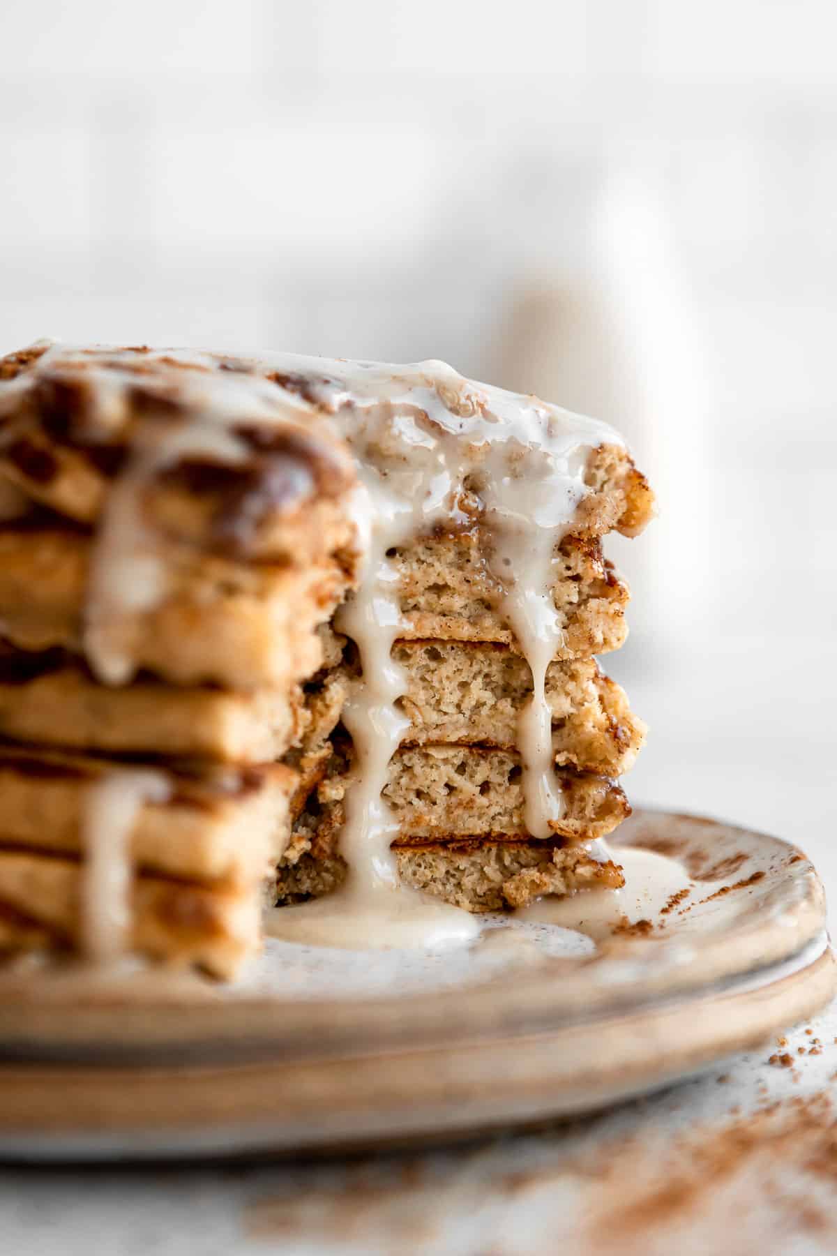 up close image of the cinnamon roll pancakes with a bite cut out