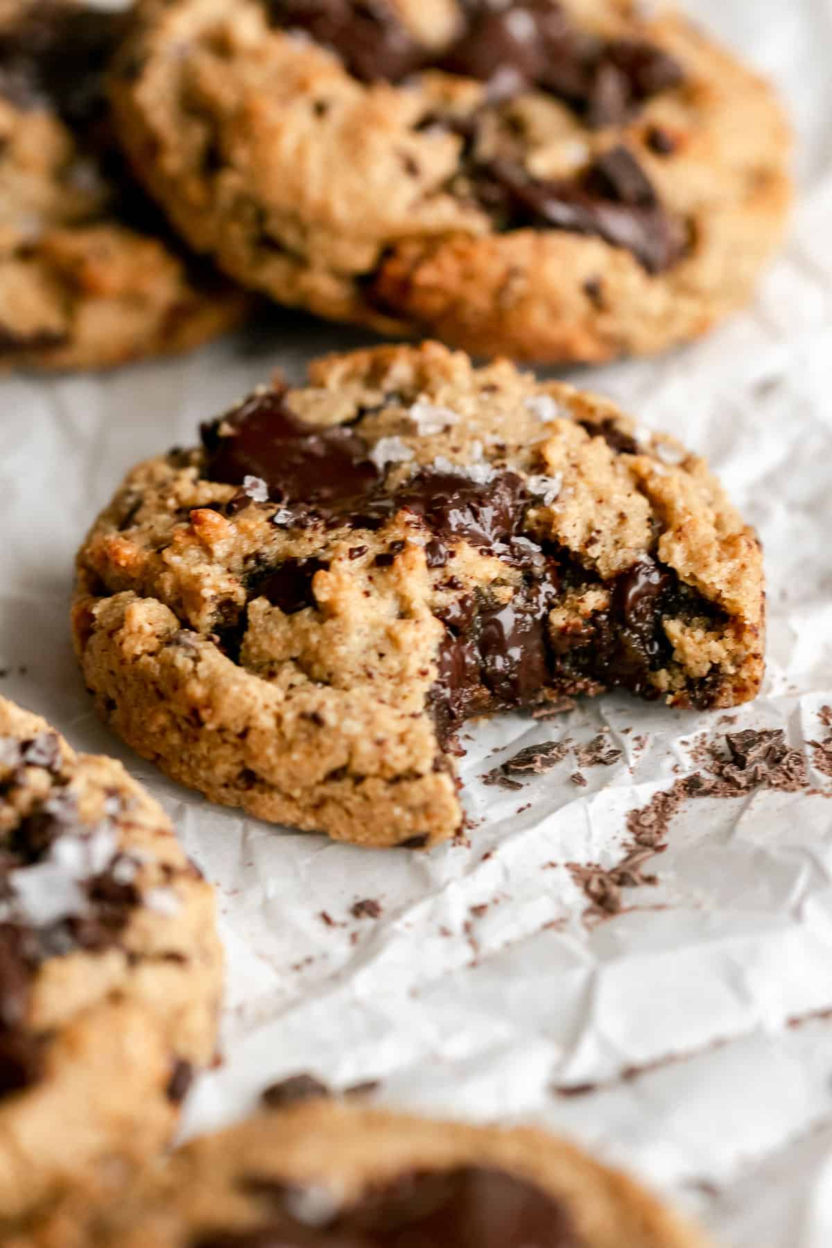 paleo chocolate chunk cookie with a bite taken out to show chewy texture