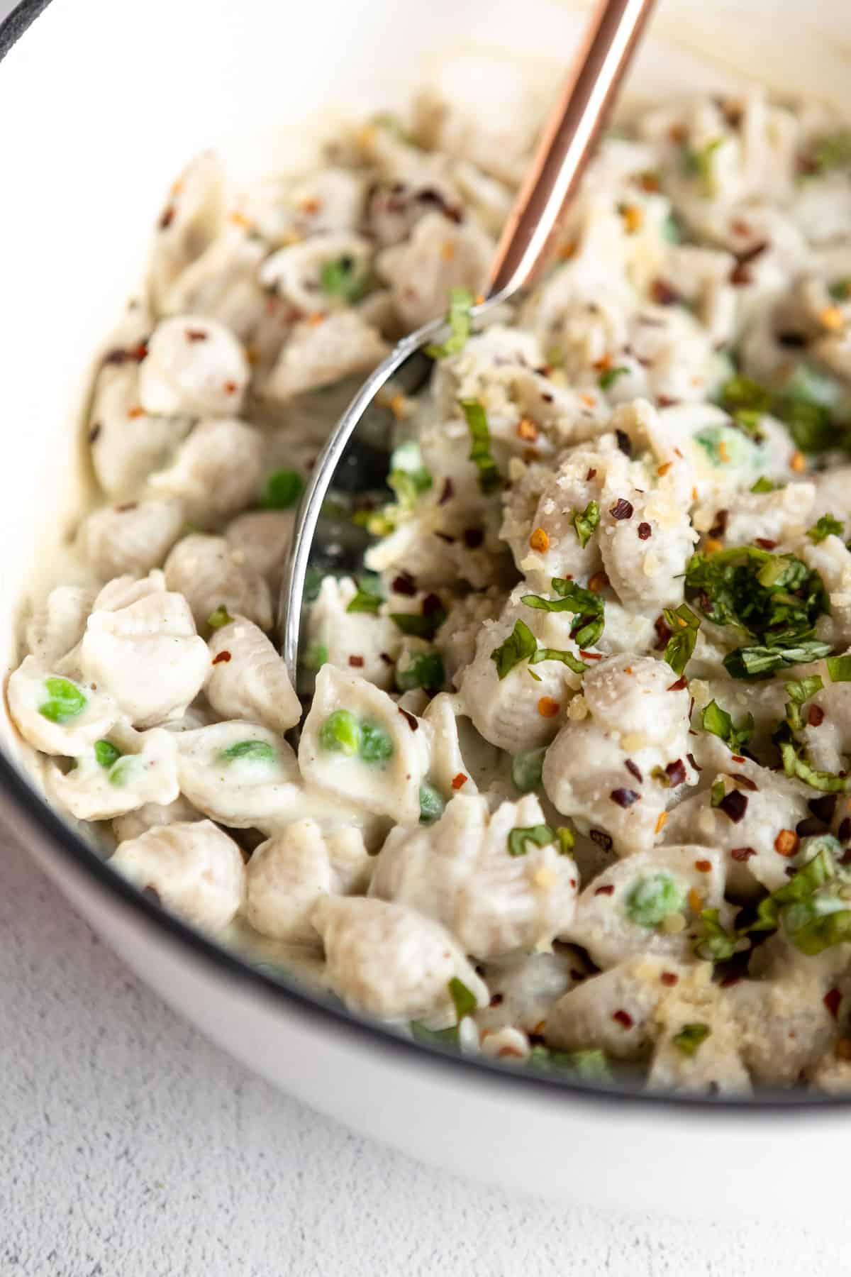cauliflower pasta in a pot with peas