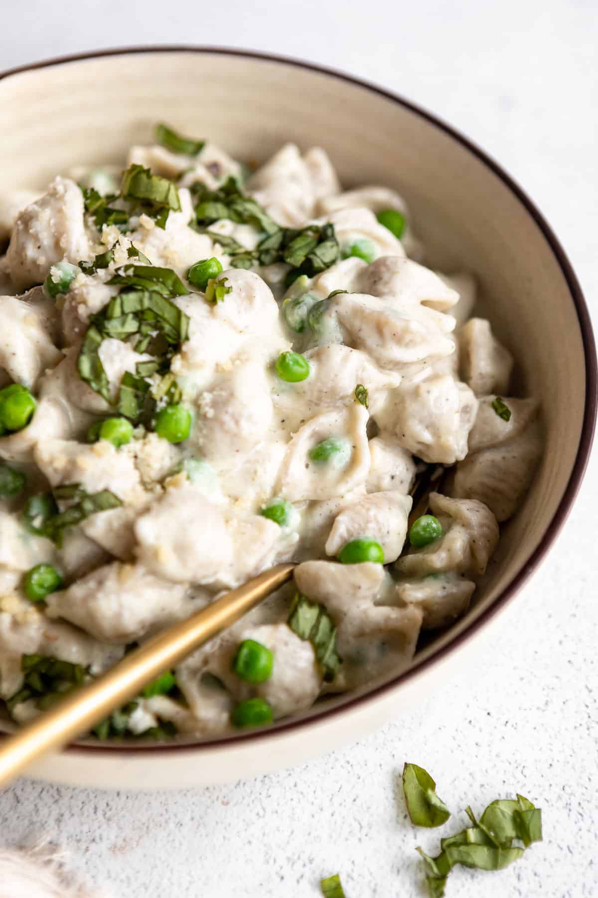 vegan cauliflower pasta in a bowl with peas