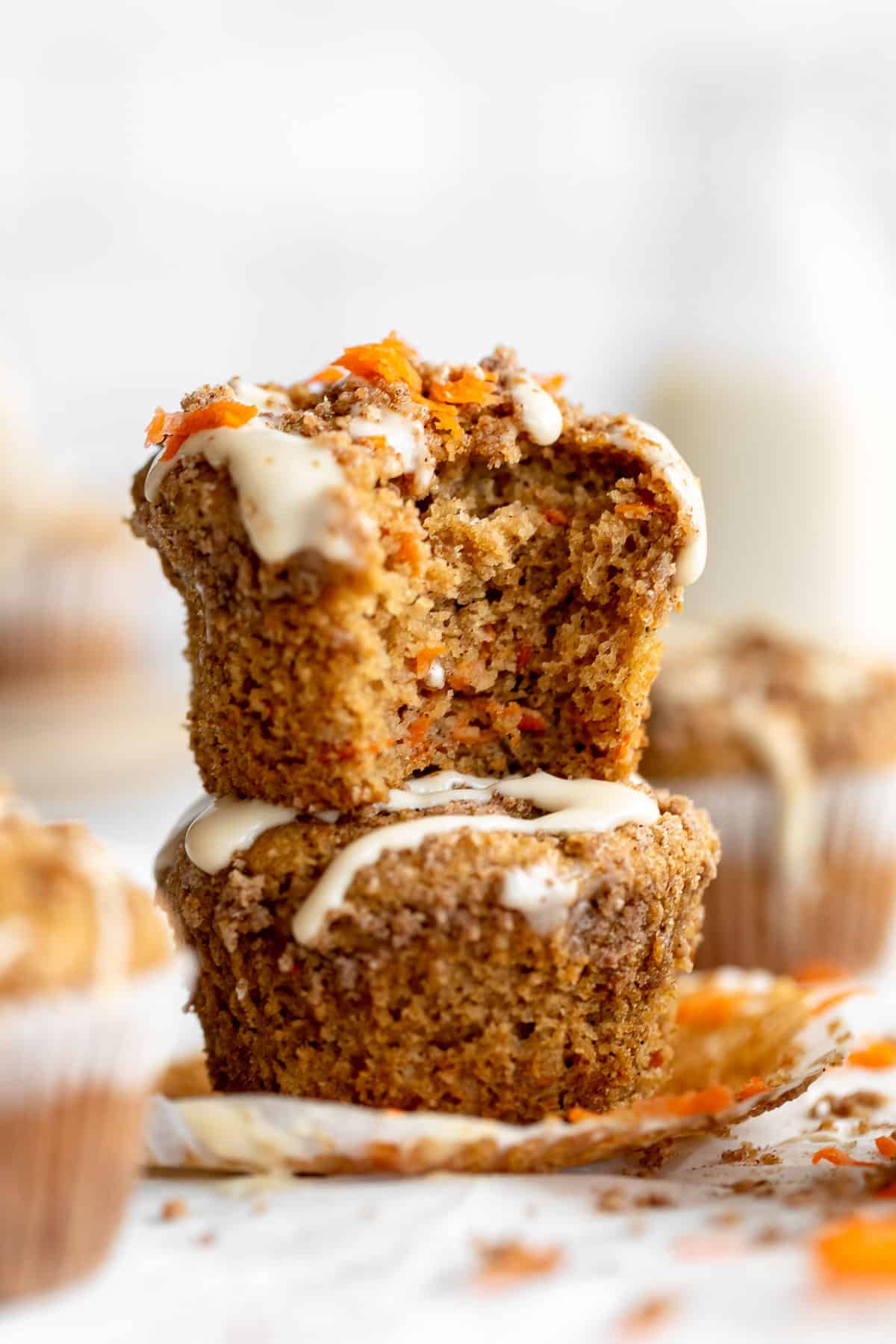 two gluten free carrot cake muffins stacked on each other