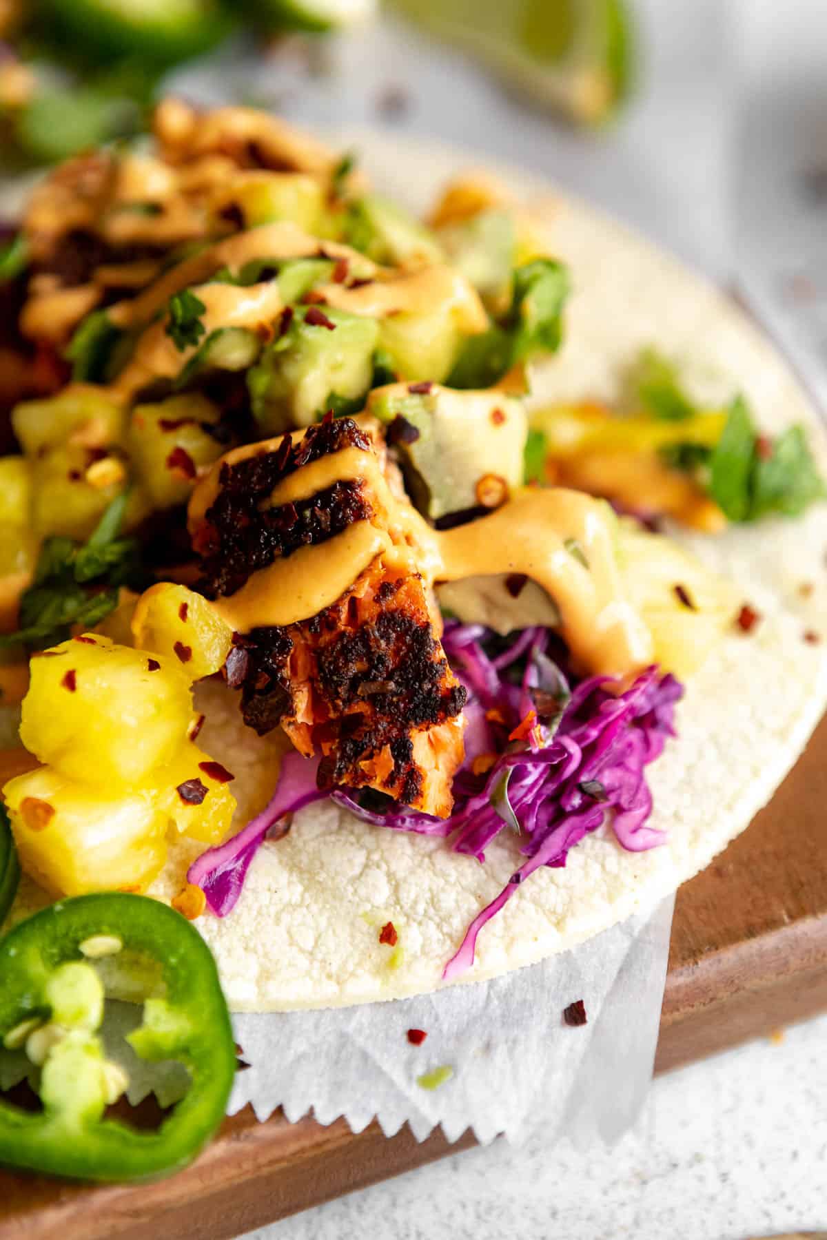 angled view of the salmon tacos with cabbage slaw and pineapple salsa