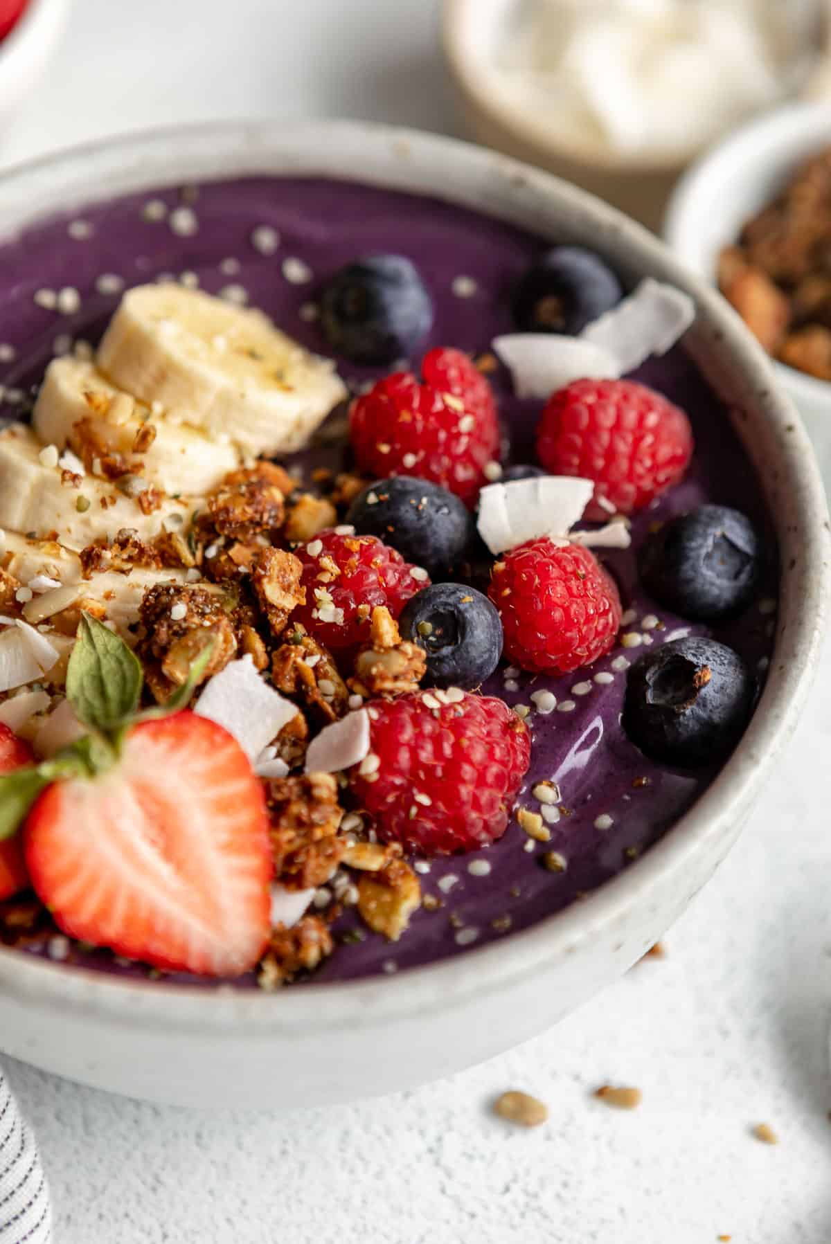 angled view of the acai bowl to show thick creamy texture