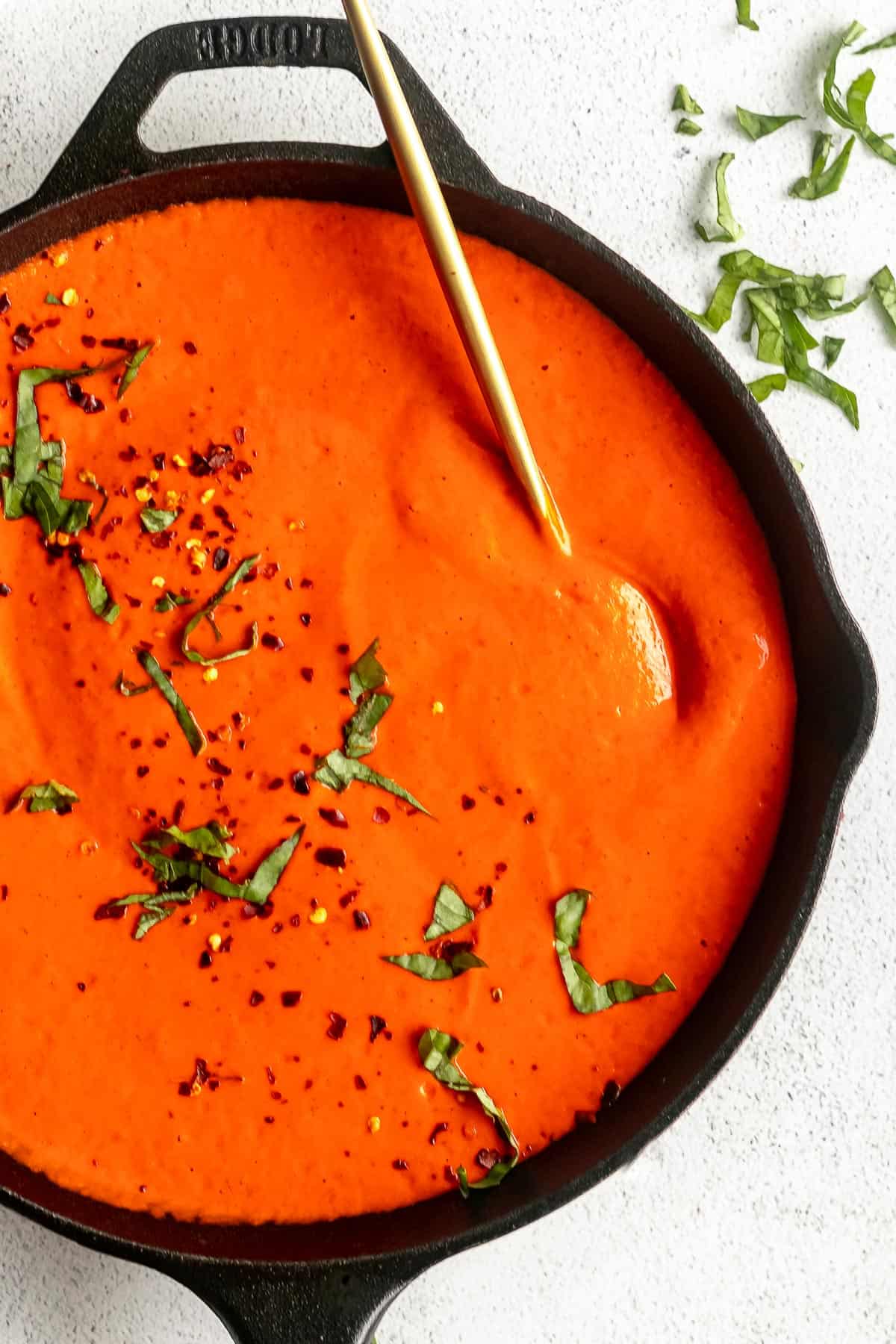 roasted red pepper sauce in a skillet with basil