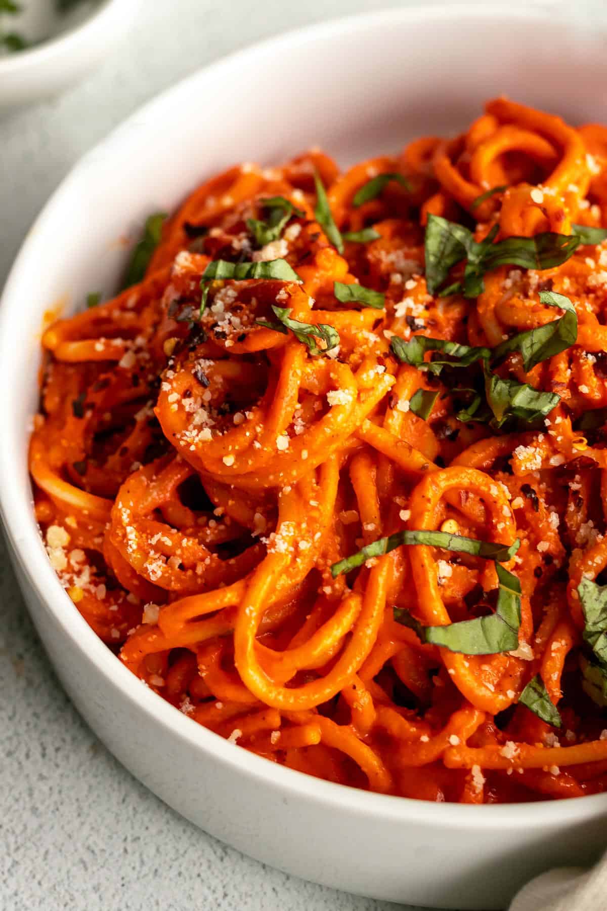 roasted red pepper sauce with spaghetti pasta in a bowl