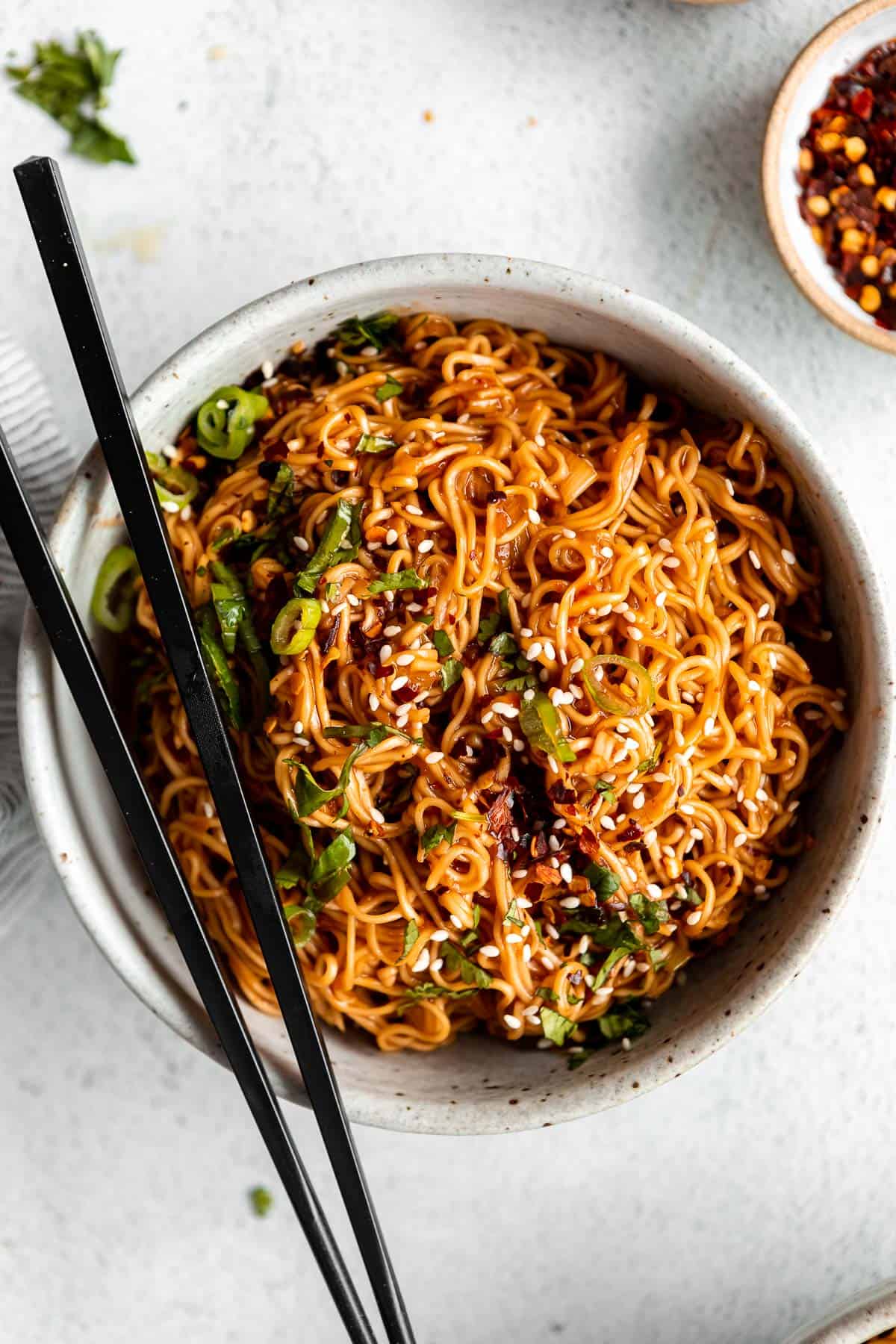 bowl of vegan ramen stir fry noodles with green onion on top