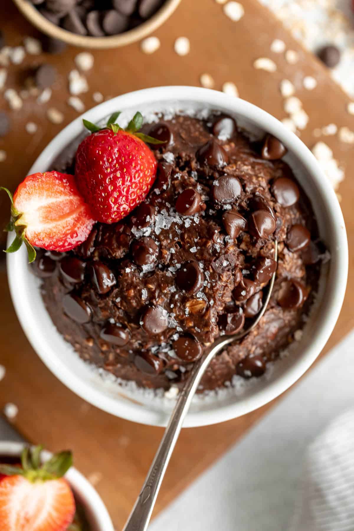 baked protein chocolate oats in a dish with berries on top