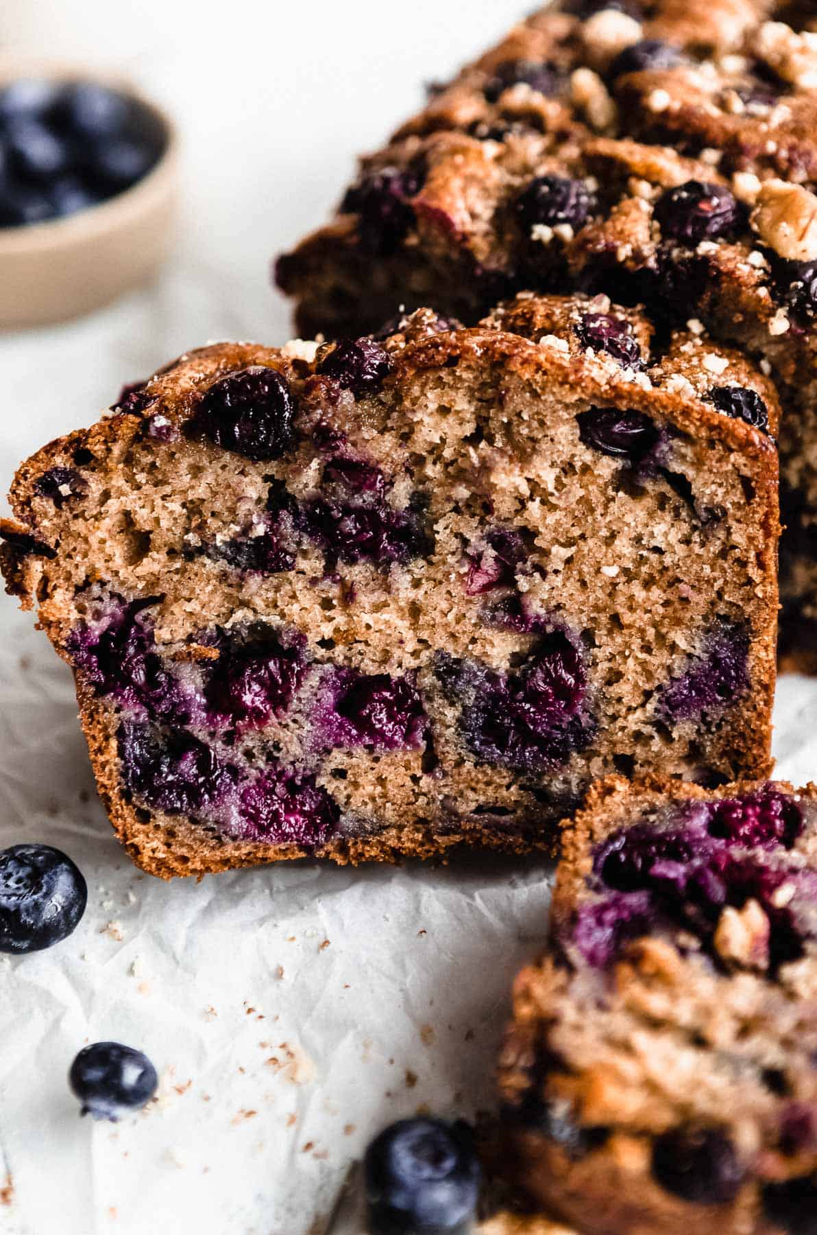 blueberry banana bread sliced on a wire rack