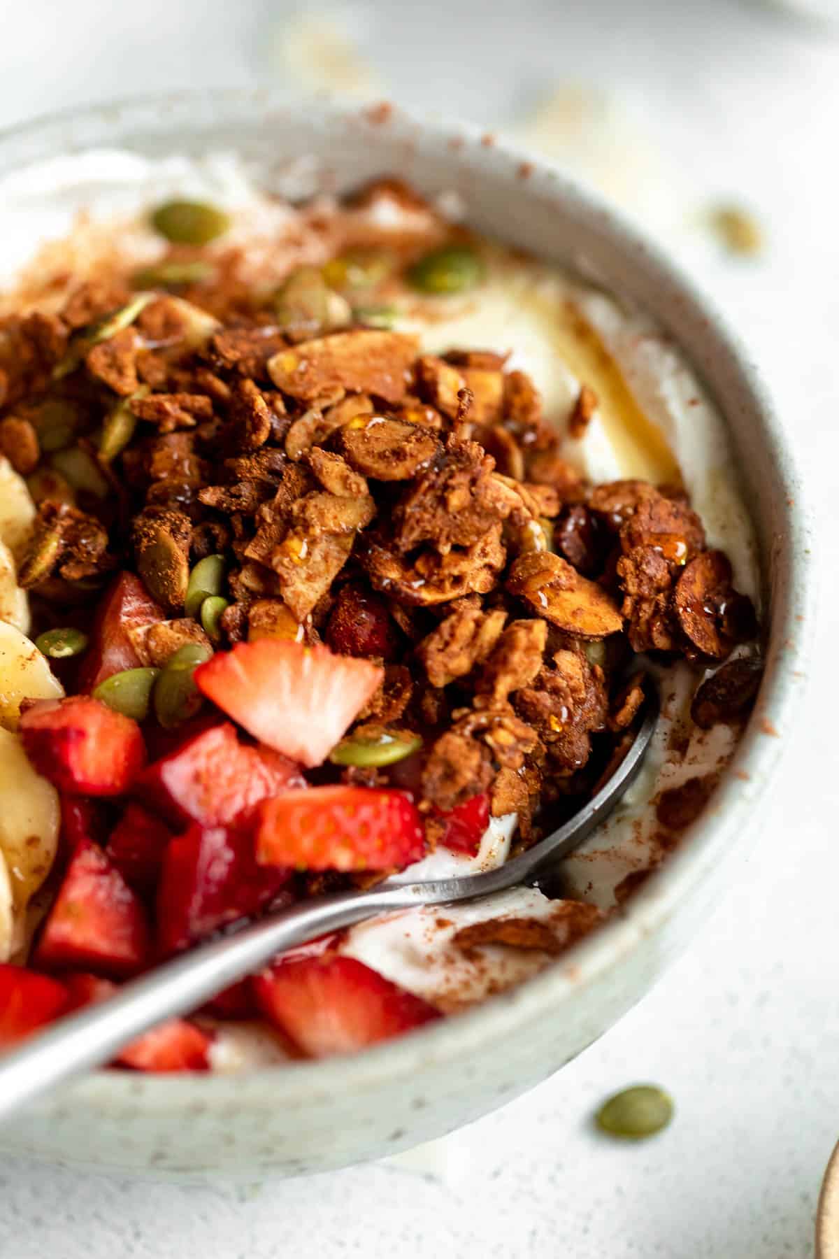 gluten free granola with yogurt and strawberries in a bowl