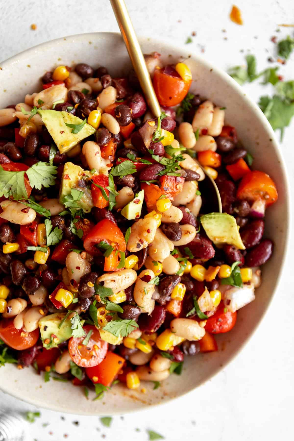 mexican three bean salad in a bowl with avocado 
