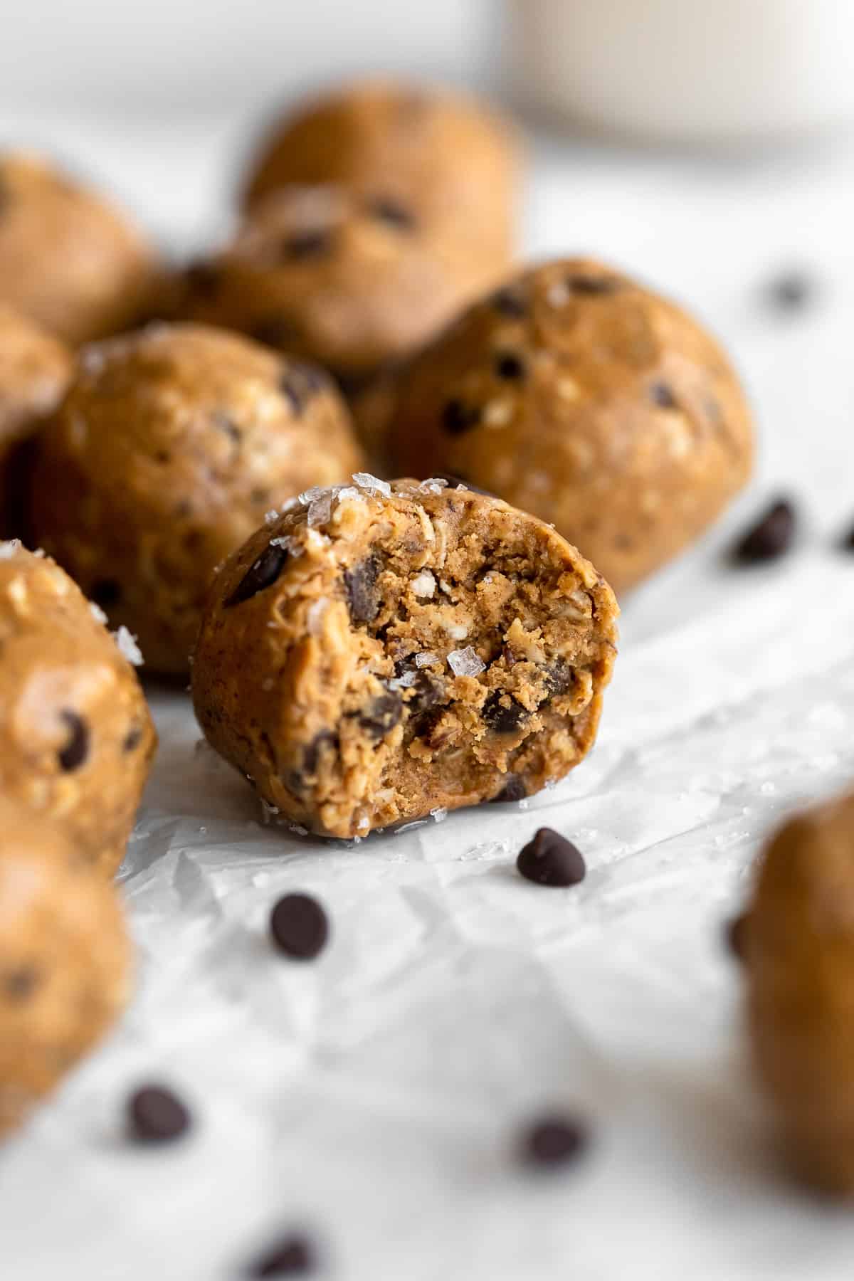 peanut butter protein balls with chocolate chips and a bite taken out