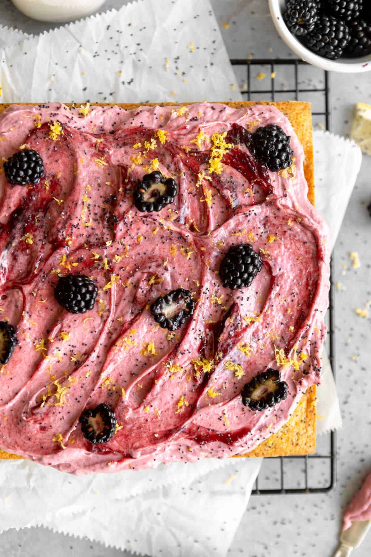 gluten free lemon poppy seed cake with blackberry buttercream on top 