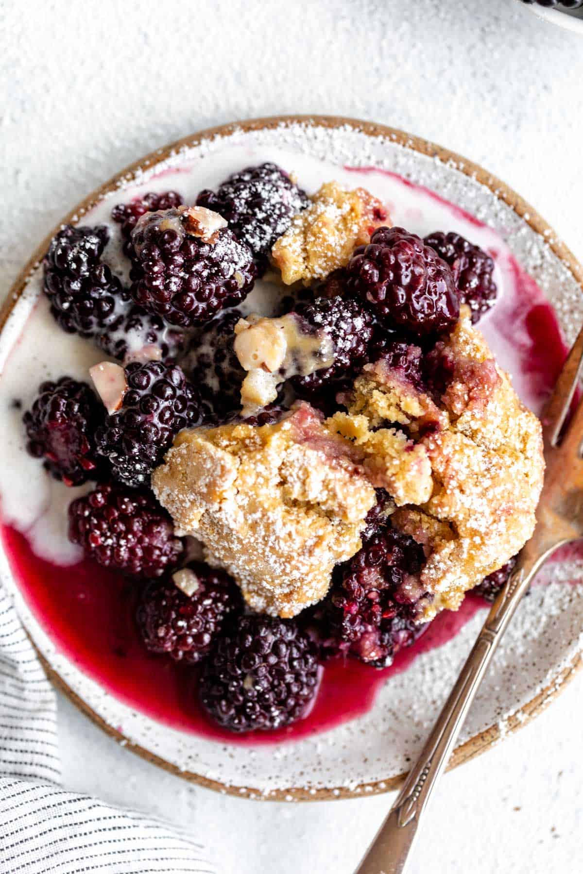 gluten free blackberry cobbler on a plate with ice cream