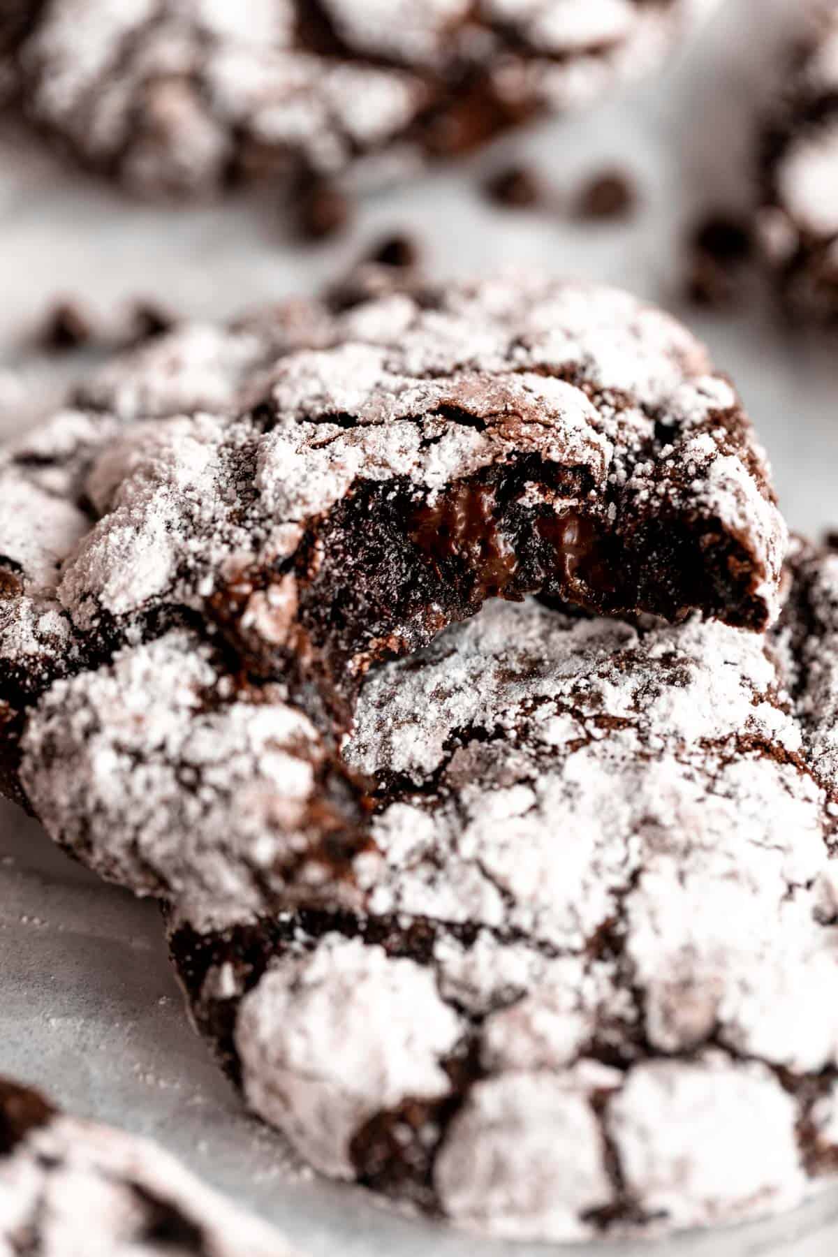 gluten free chocolate crinkle cookies with a bite taken out