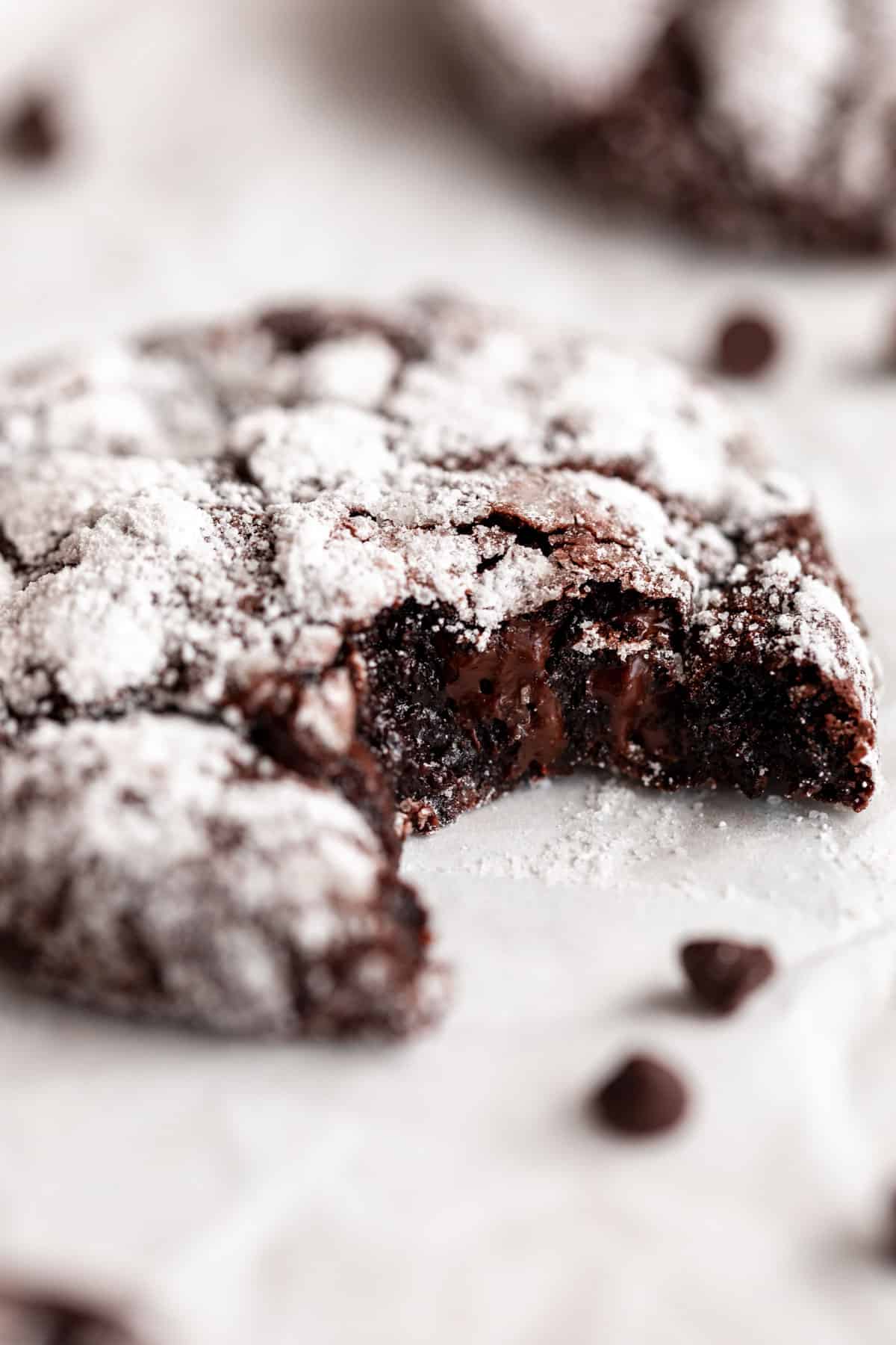 gluten free chocolate cookies with a bite taken out to show fudgy texture