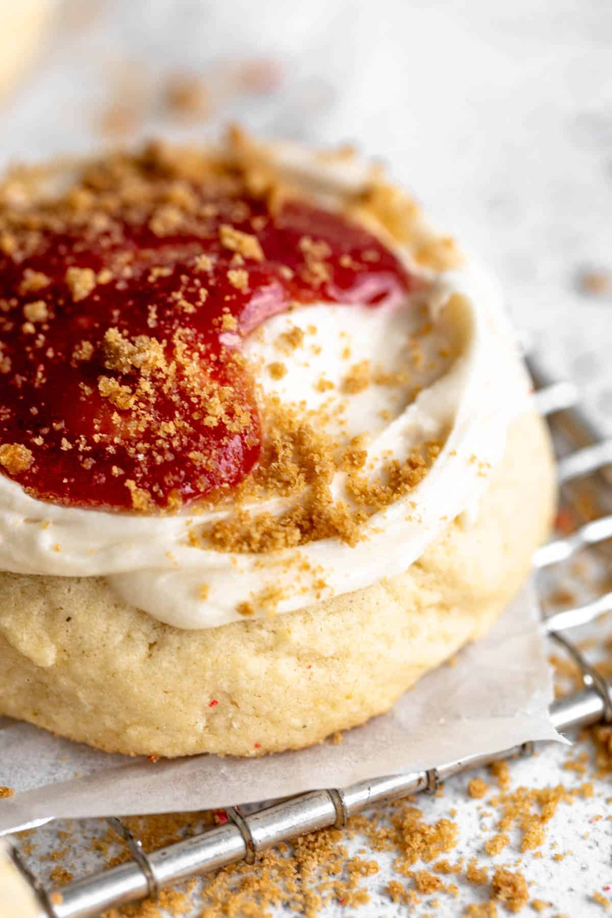 gluten free crumbl cookies with frosting and jam on top