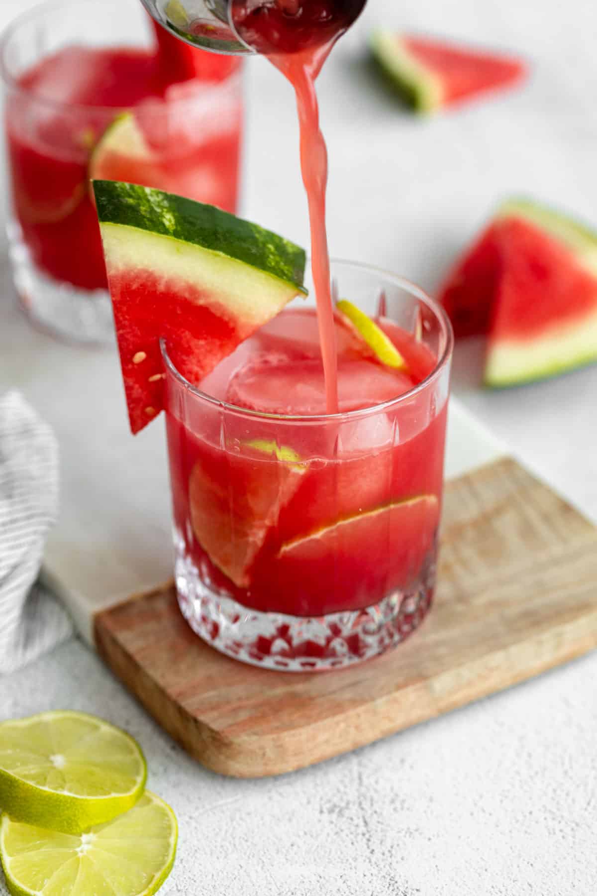 pouring the watermelon vodka cocktail into a glass
