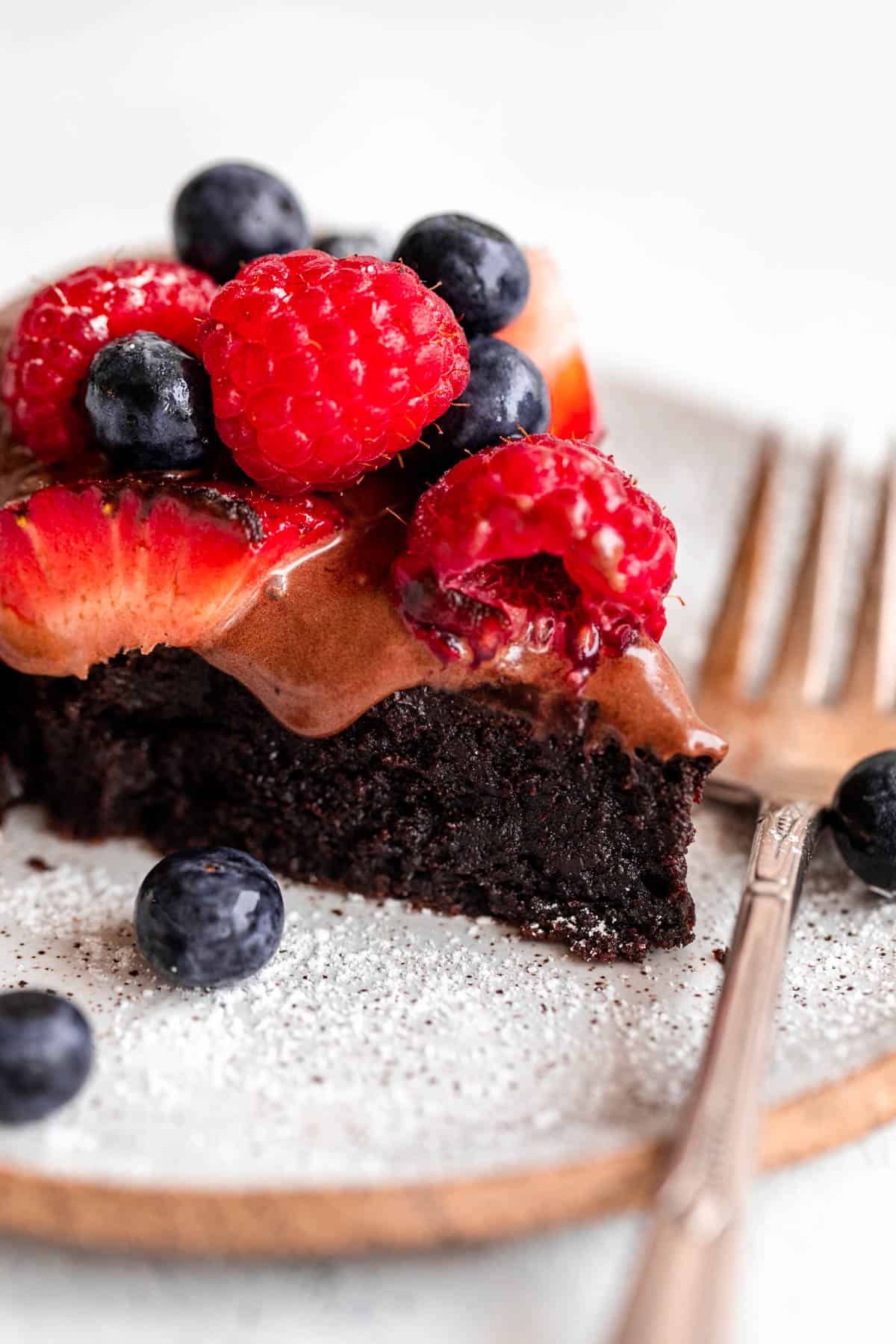 up close of a slice of the flourless cake with berries