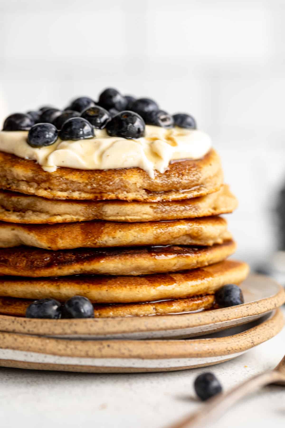 side view of the pancakes with yogurt and berries on top